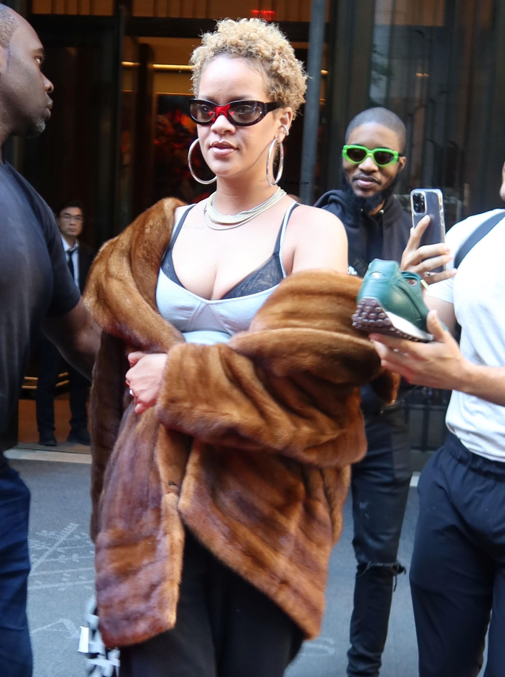 Rihanna wears her hair in natural curls