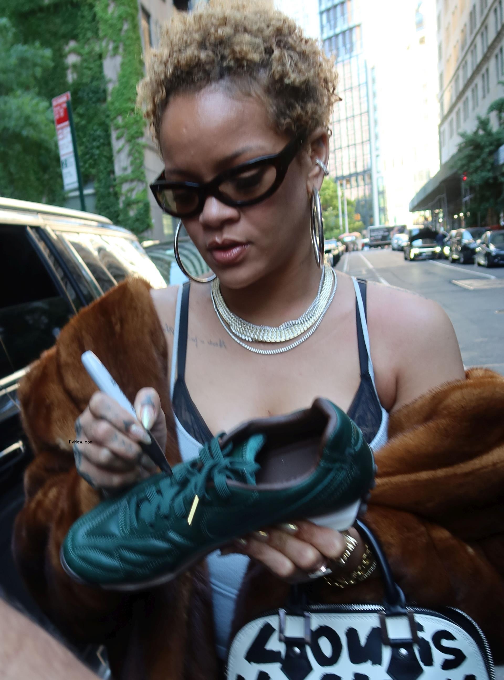 Rihanna wears her hair in natural curls