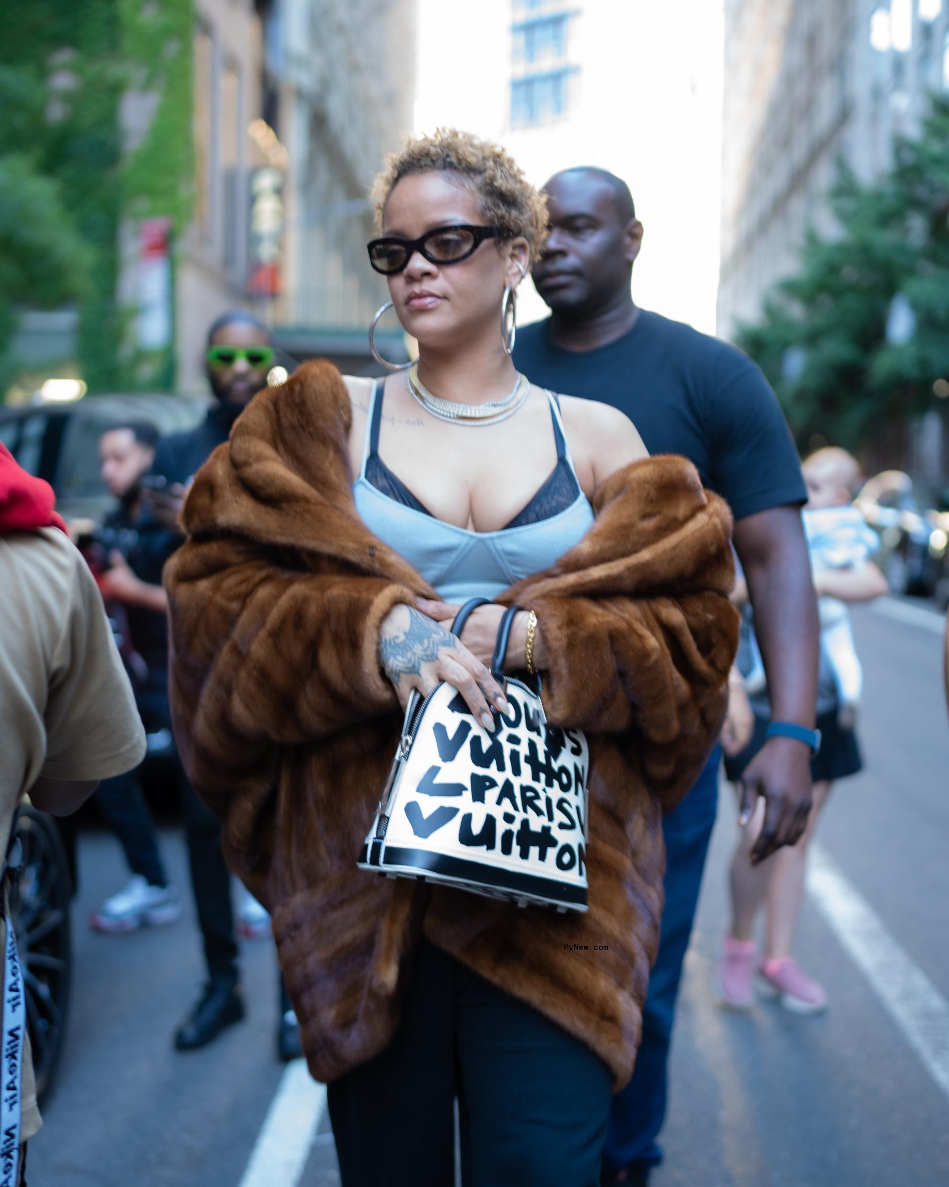 Rihanna wears her hair in natural curls
