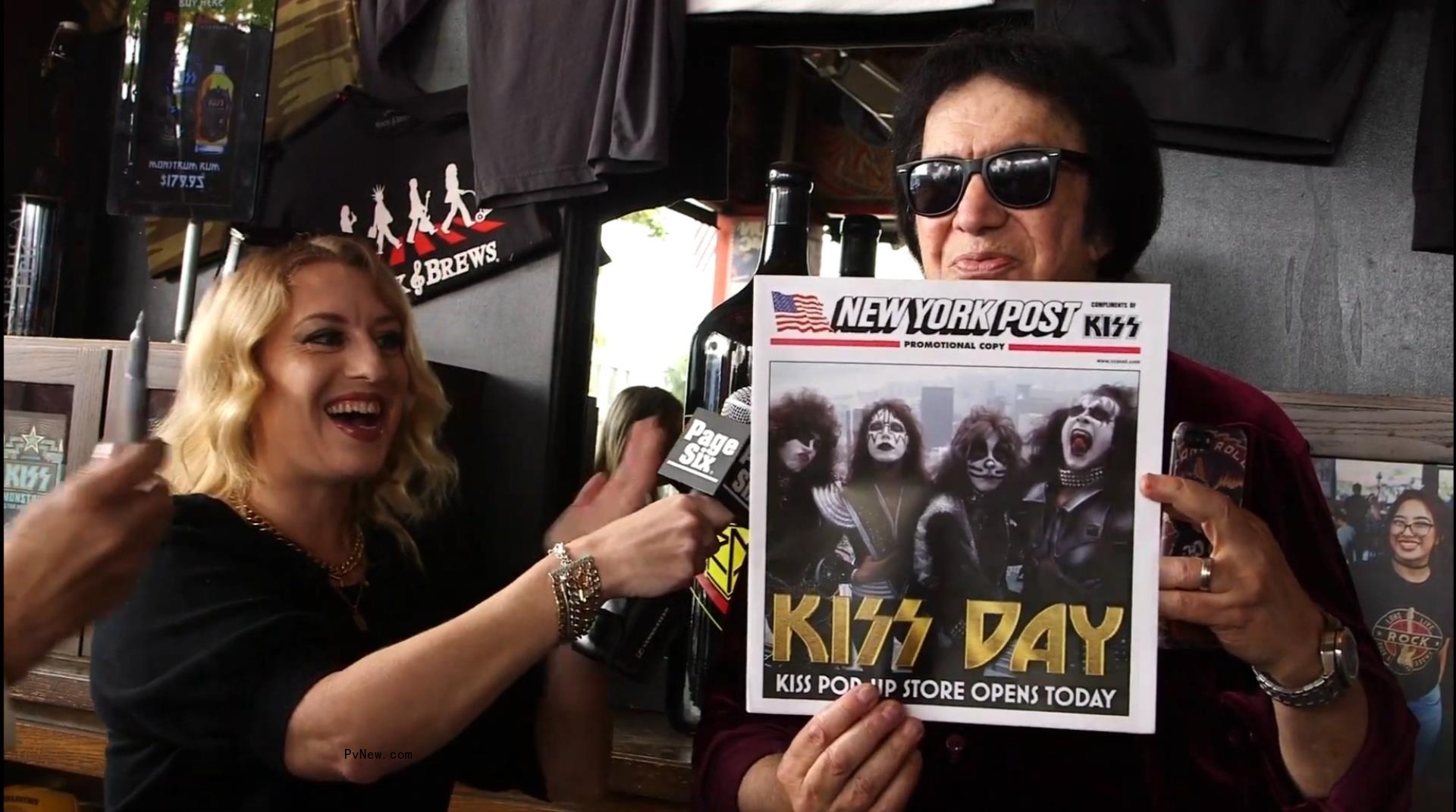 A photo of KISS rocker Gene Simmons holding up a copy of the New York Post with Pvnew reporter Desiree Murphy