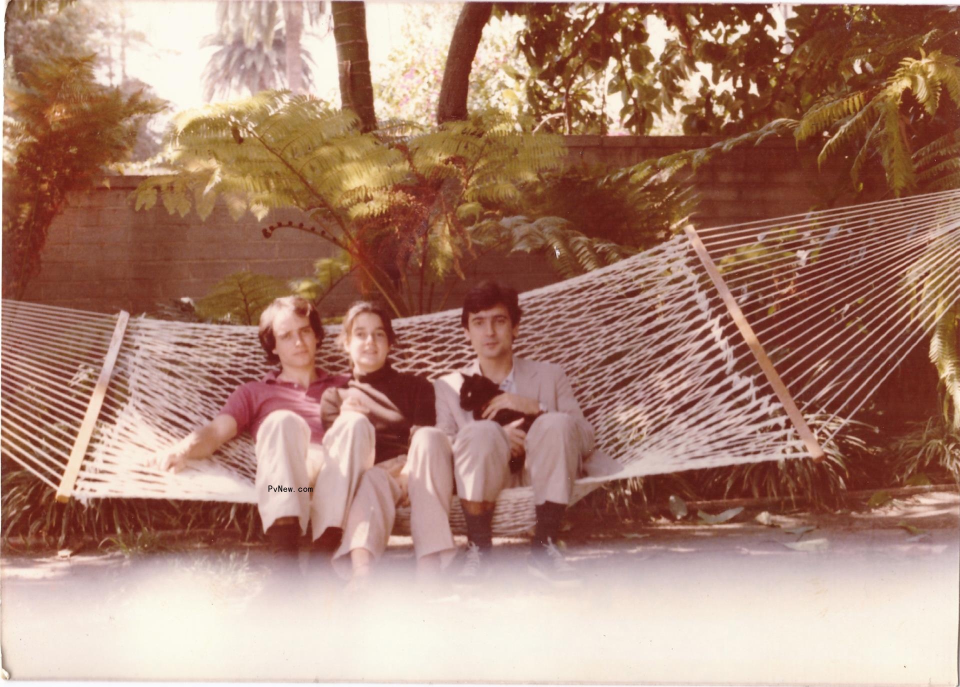 Alex Dunne, Dominique Dunne and Griffin Dunne, holding a cat, all sitting in a hammock