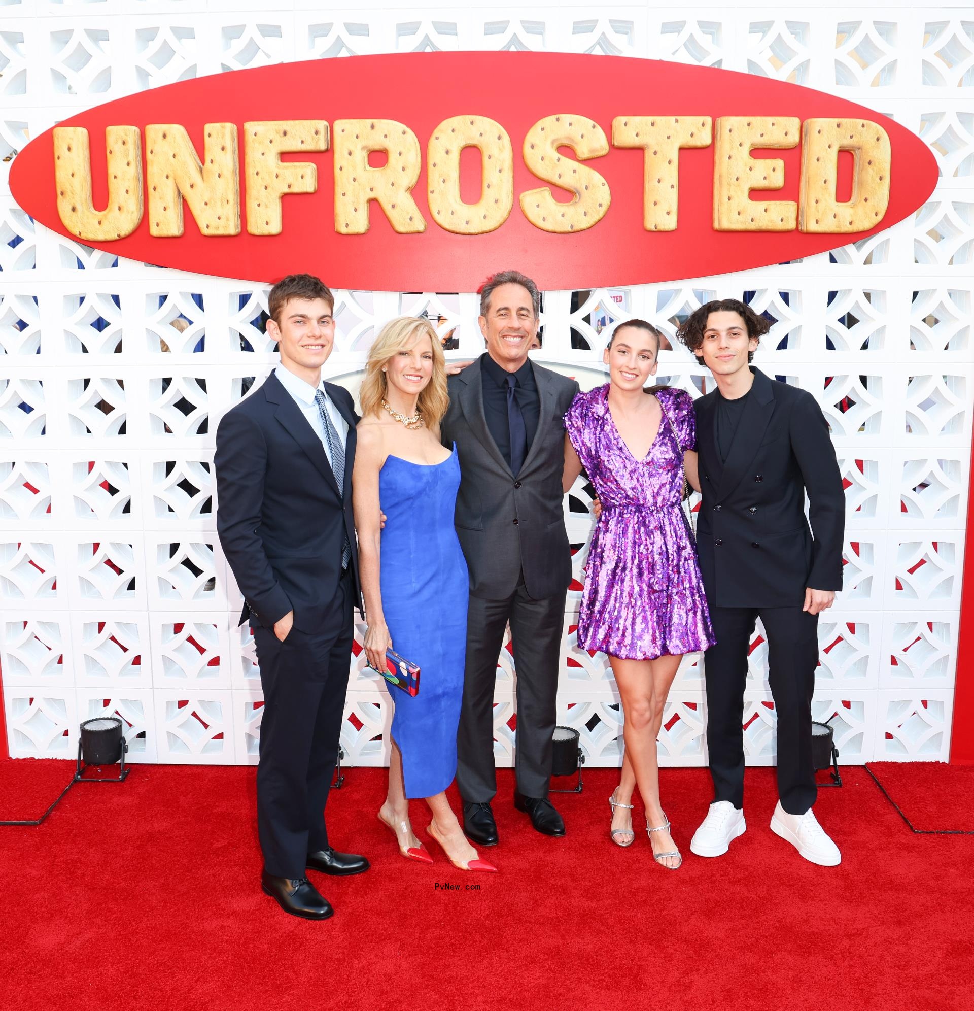Jerry and Jessica Seinfeld with their kids Julian, Shepard, and Sascha on a red carpet.