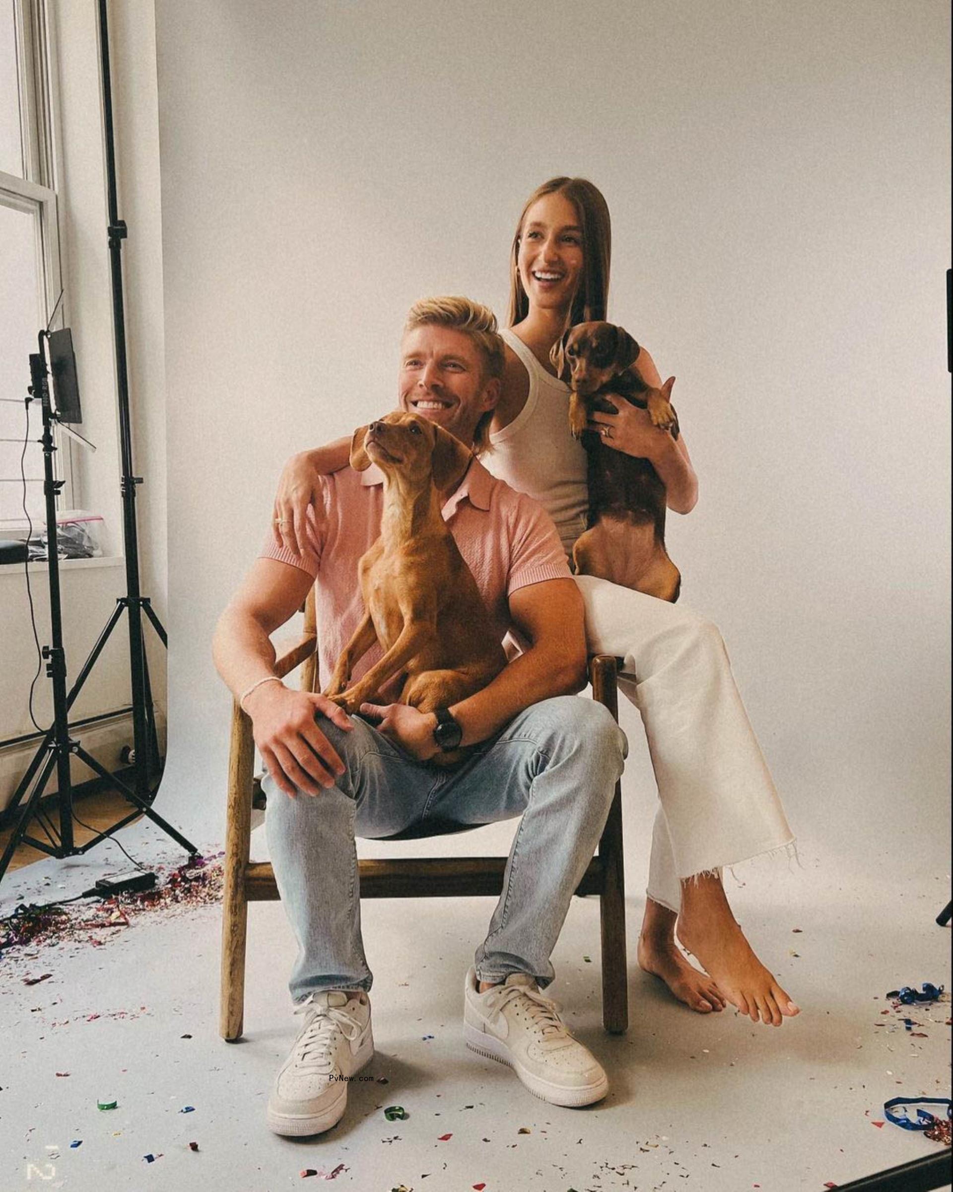 Kyle Cooke and Amanda Batula sitting with their dogs