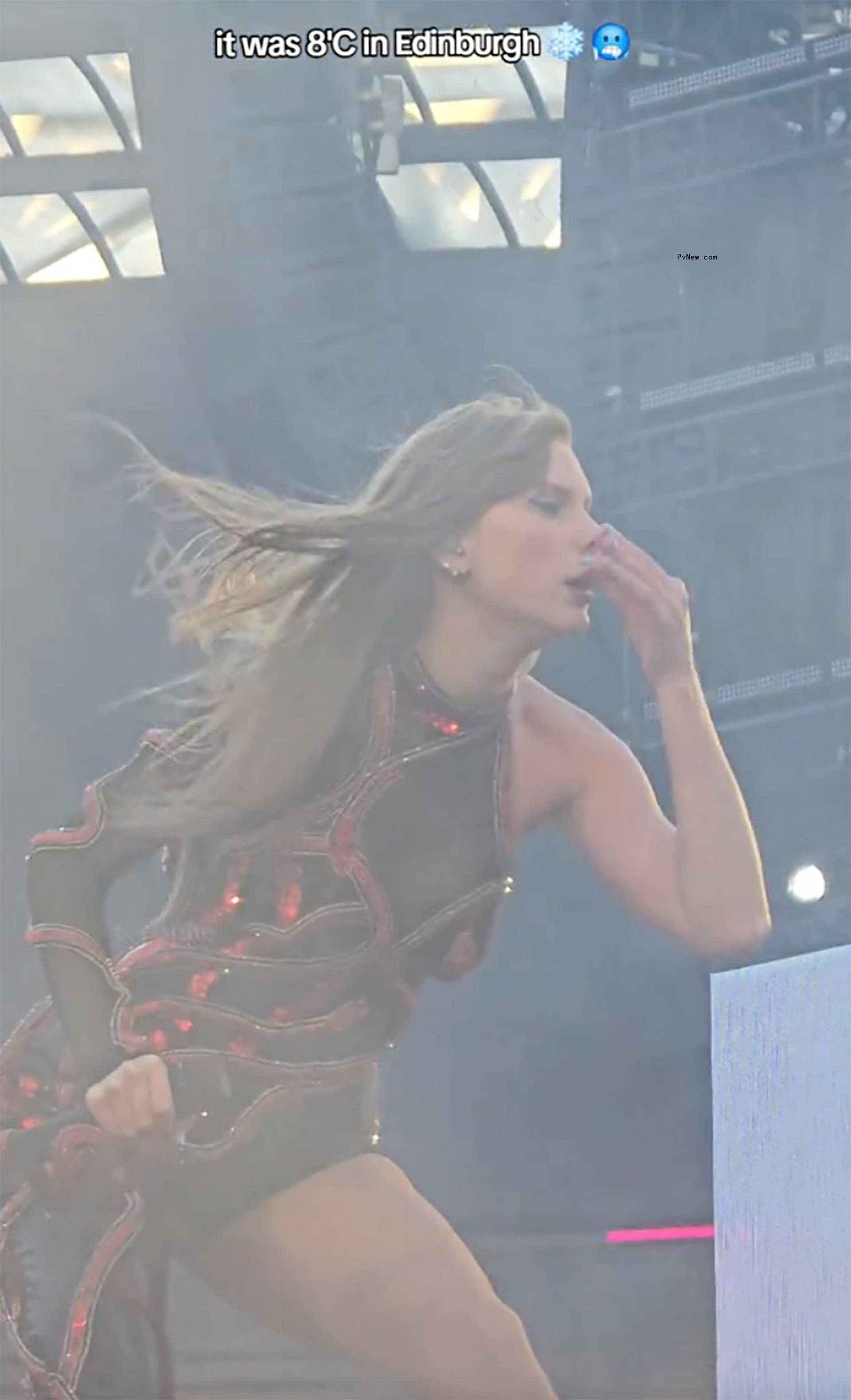 Taylor Swift wiping her nose.