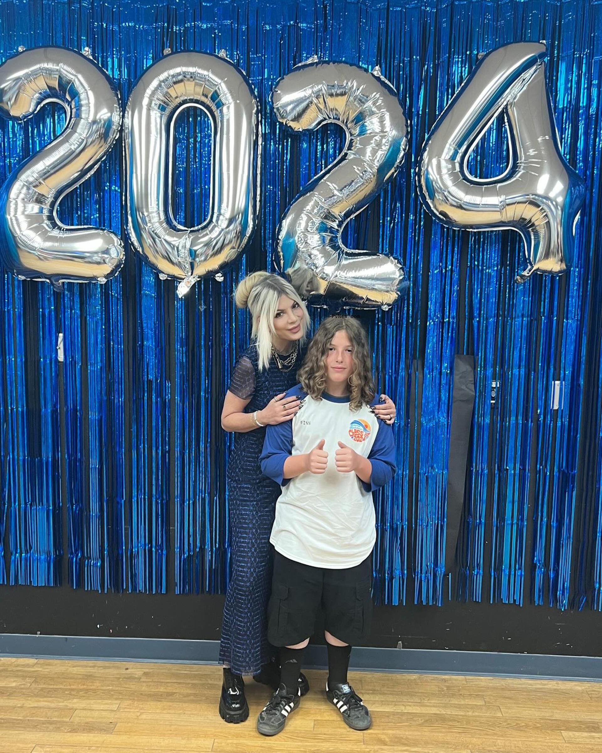 Tori Spelling and her son Finn posing at his graduation