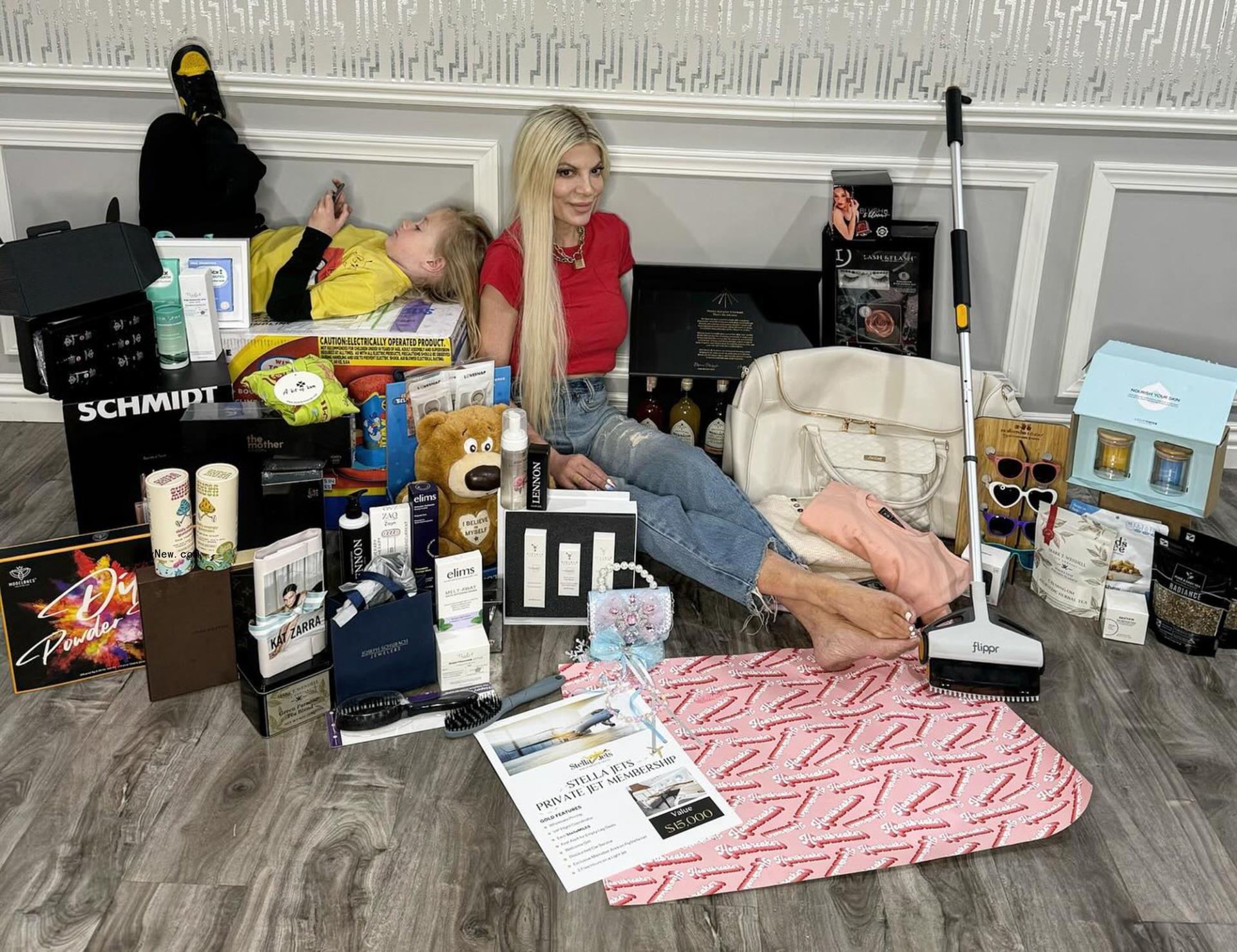 Tori Spelling sitting with household items