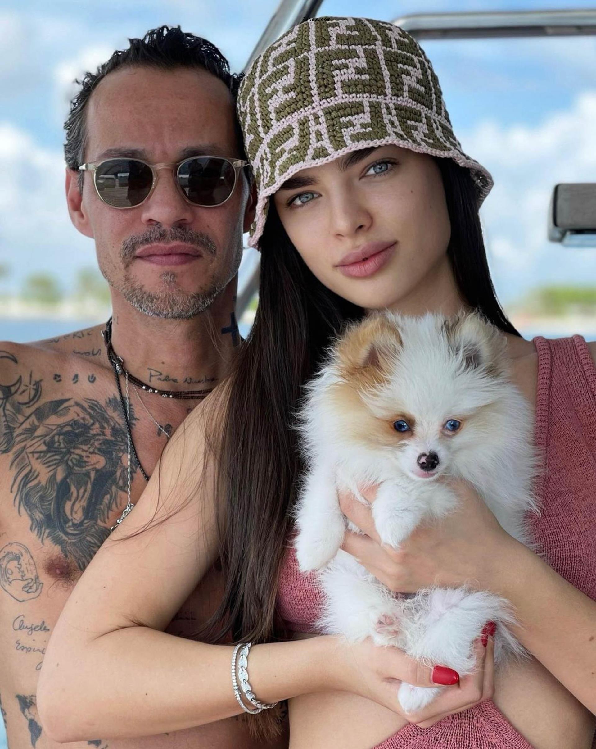 Nadia Ferreira and Marc Anthony with their dog.