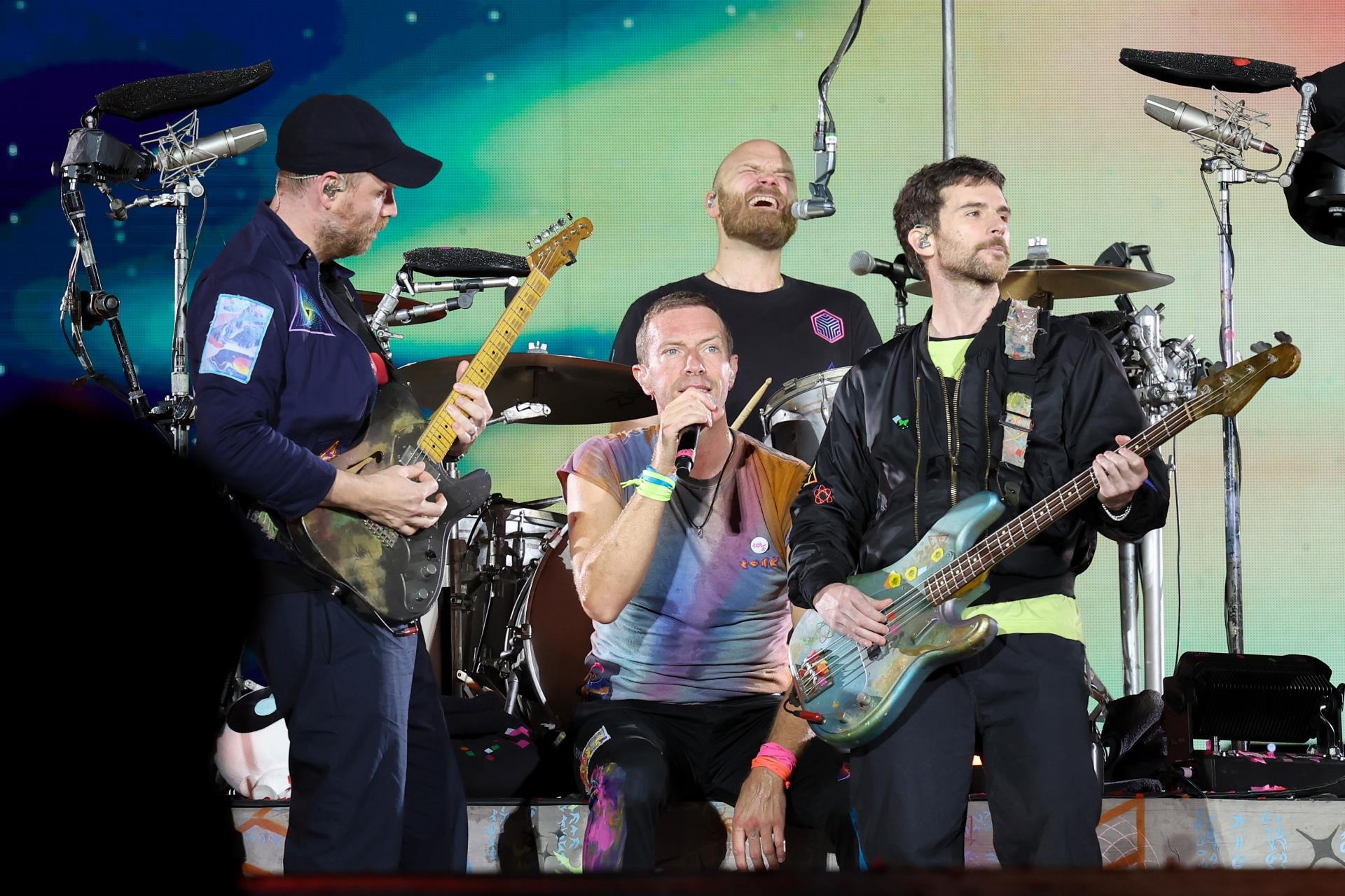 Chris Martin sitting onstage.