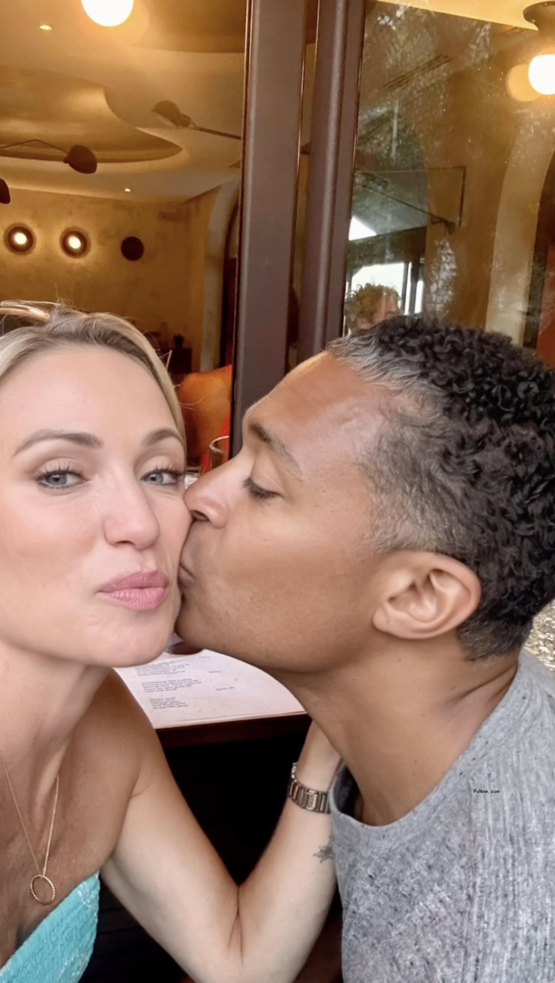 A selfie of T.J. Holmes kissing Amy Robach on the cheek.