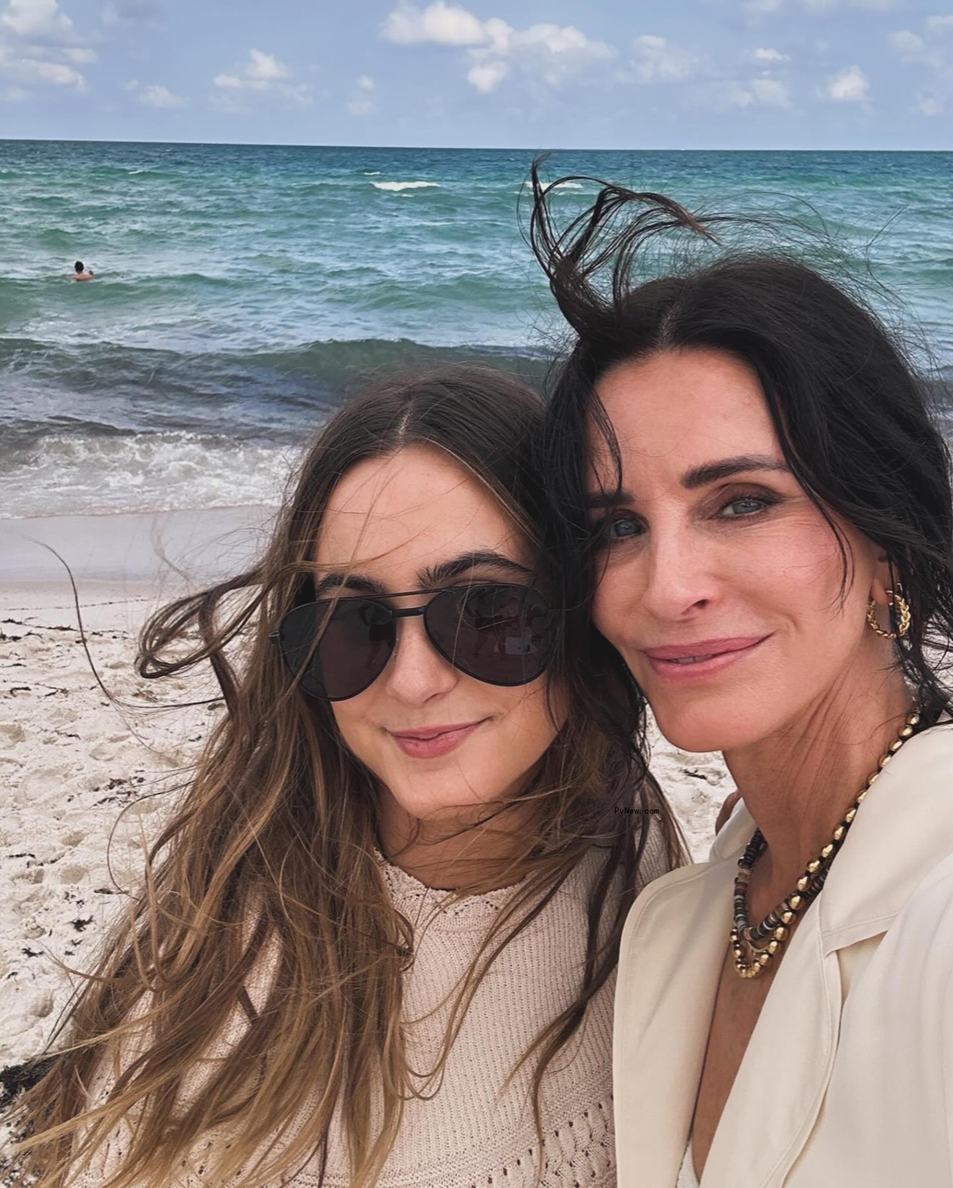 Coco Arquette and Courteney Cox in a selfie on a beach.