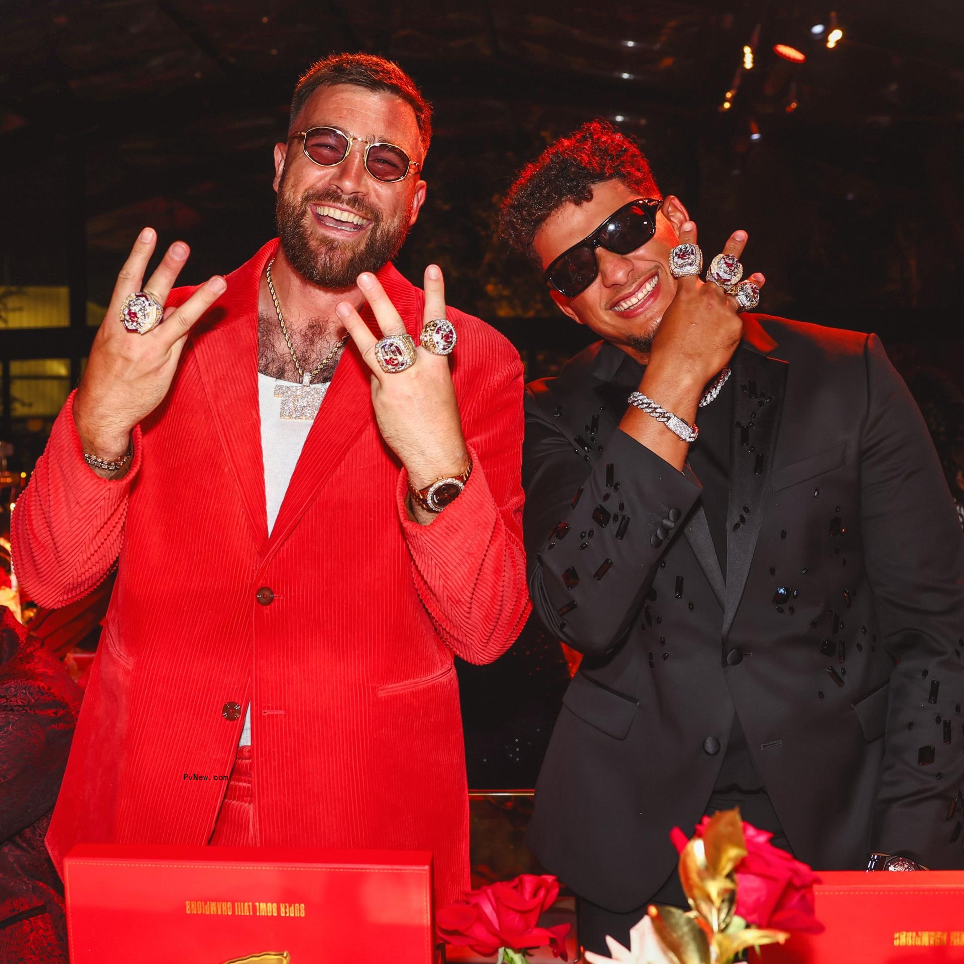 Travis Kelce wearing a red suit at the Chiefs Super Bowl ring ceremony