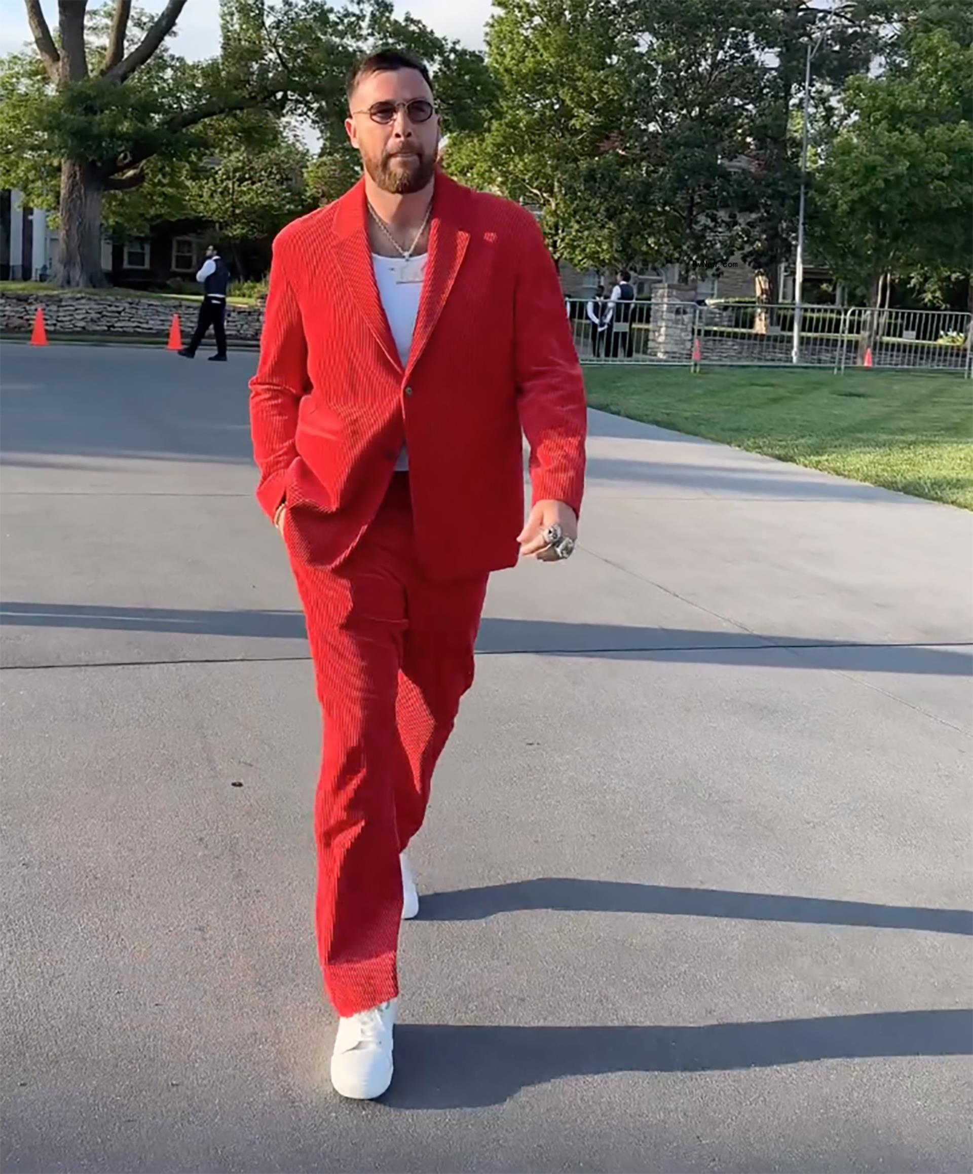 Travis Kelce wearing a red suit at the Chiefs Super Bowl ring ceremony