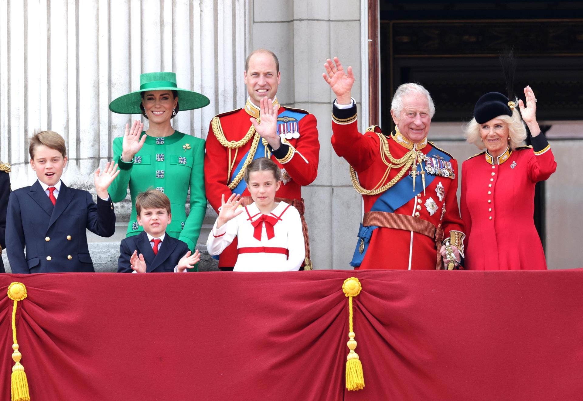 The royal family waving at a Buckingham Palace balcony.