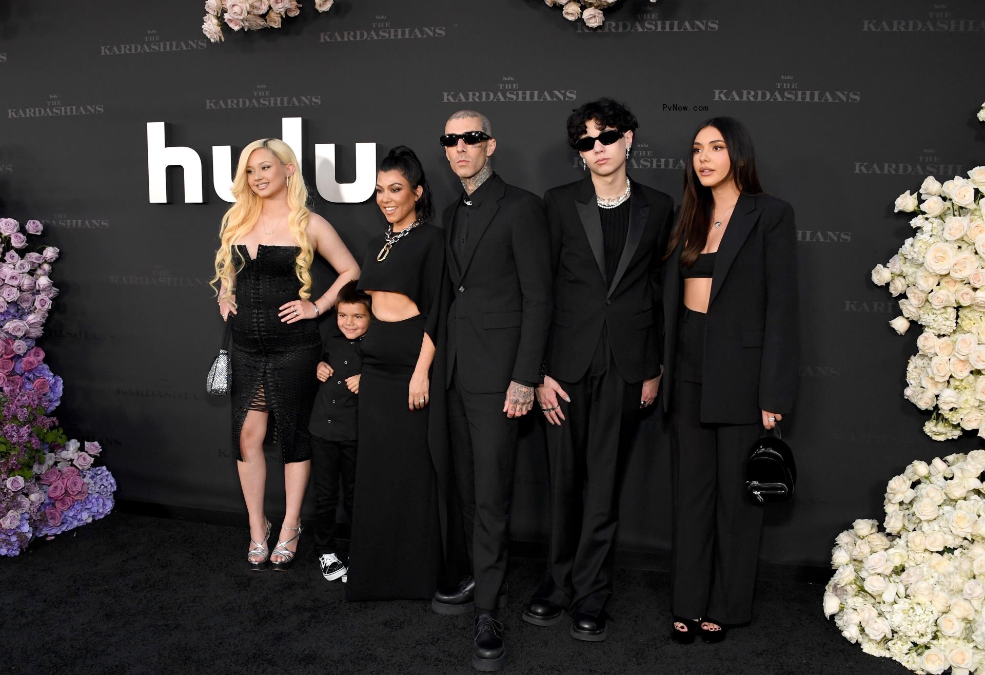 Kourtney Kardashian posing with her three kids.