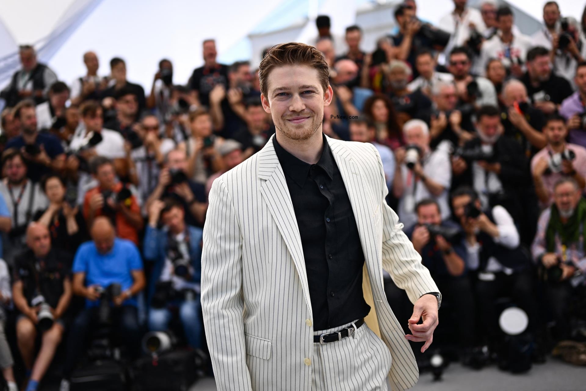 Joe Alwyn posing on a red carpet