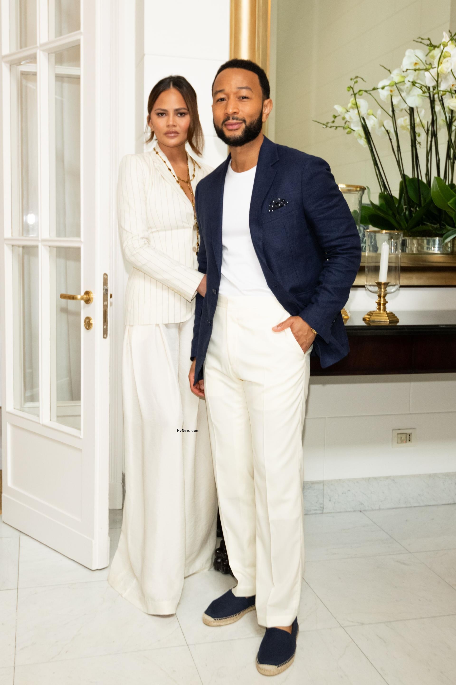 John legend and Chrissy Teigen posing for a photo together. 