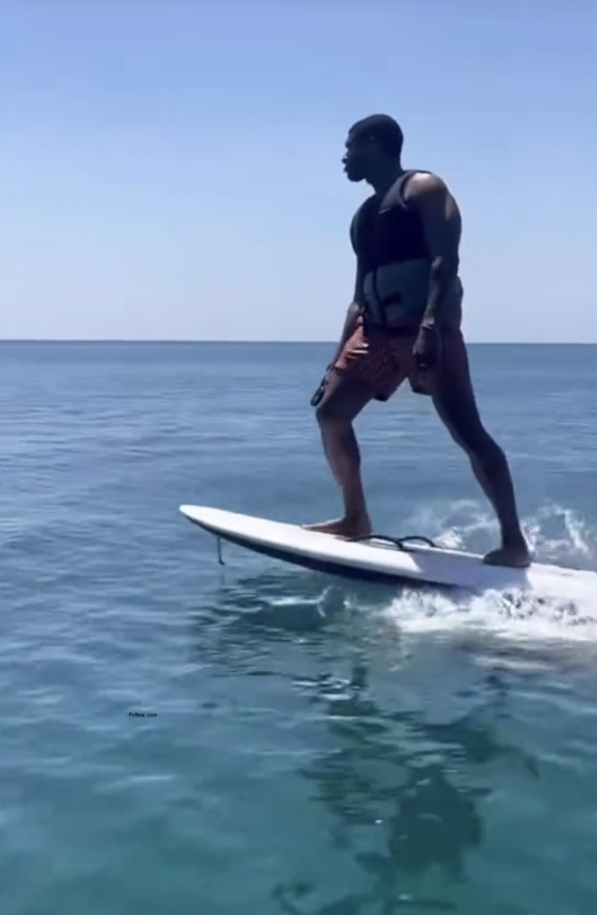 Usher surfing.