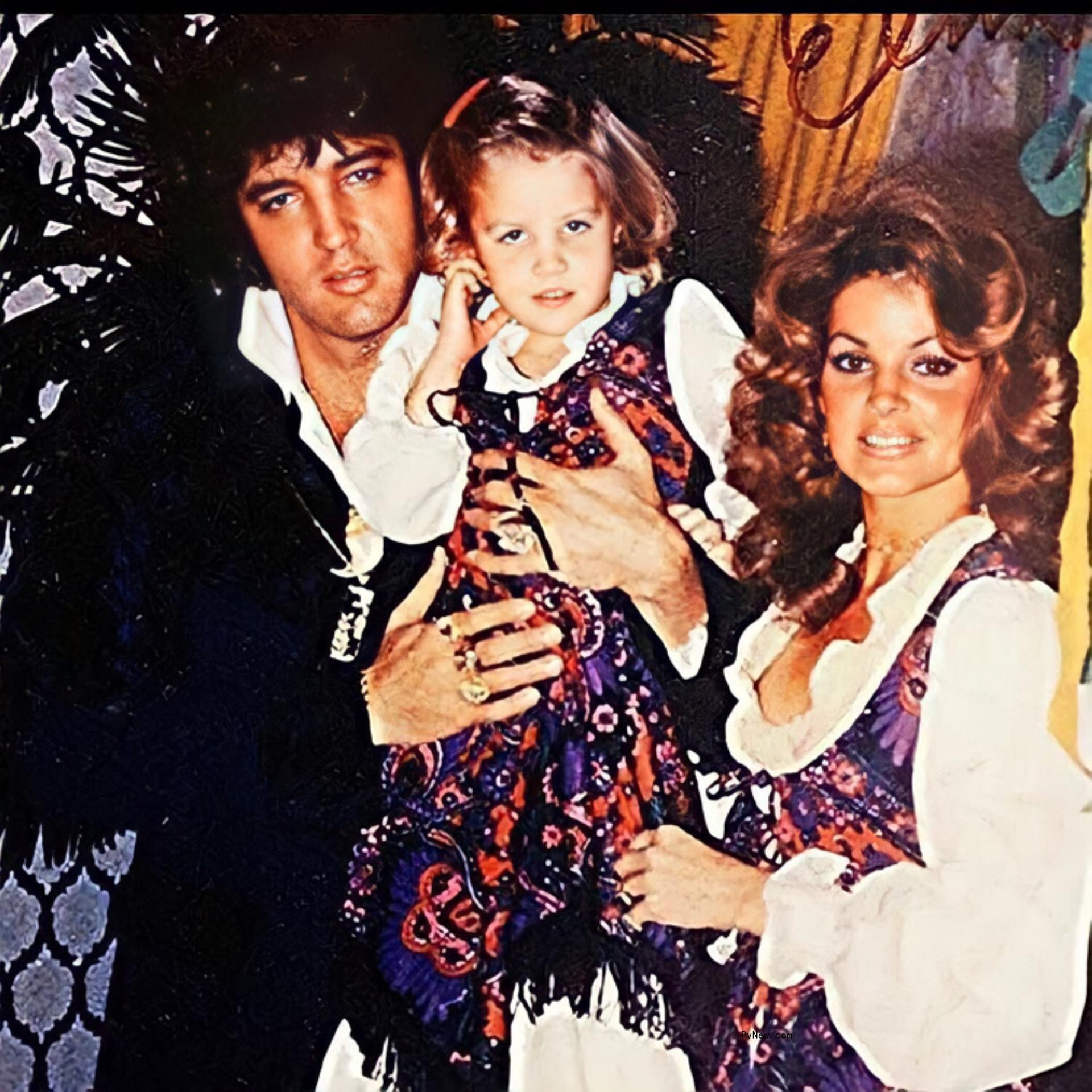 Elvis Presley holds Lisa Marie Presley alo<i></i>ngside Priscilla Presley.