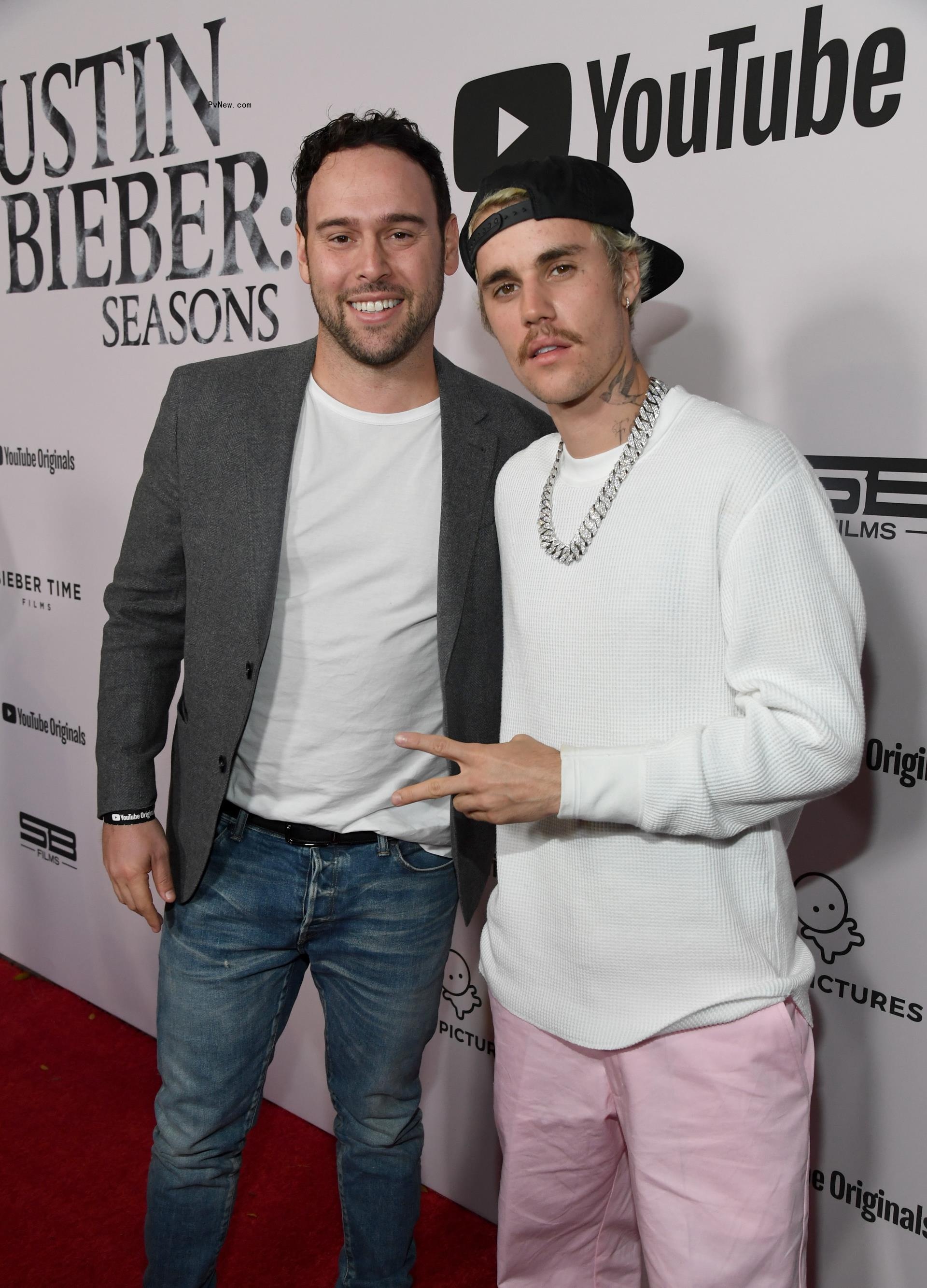 Scooter Braun with Justin Bieber on a red carpet. 