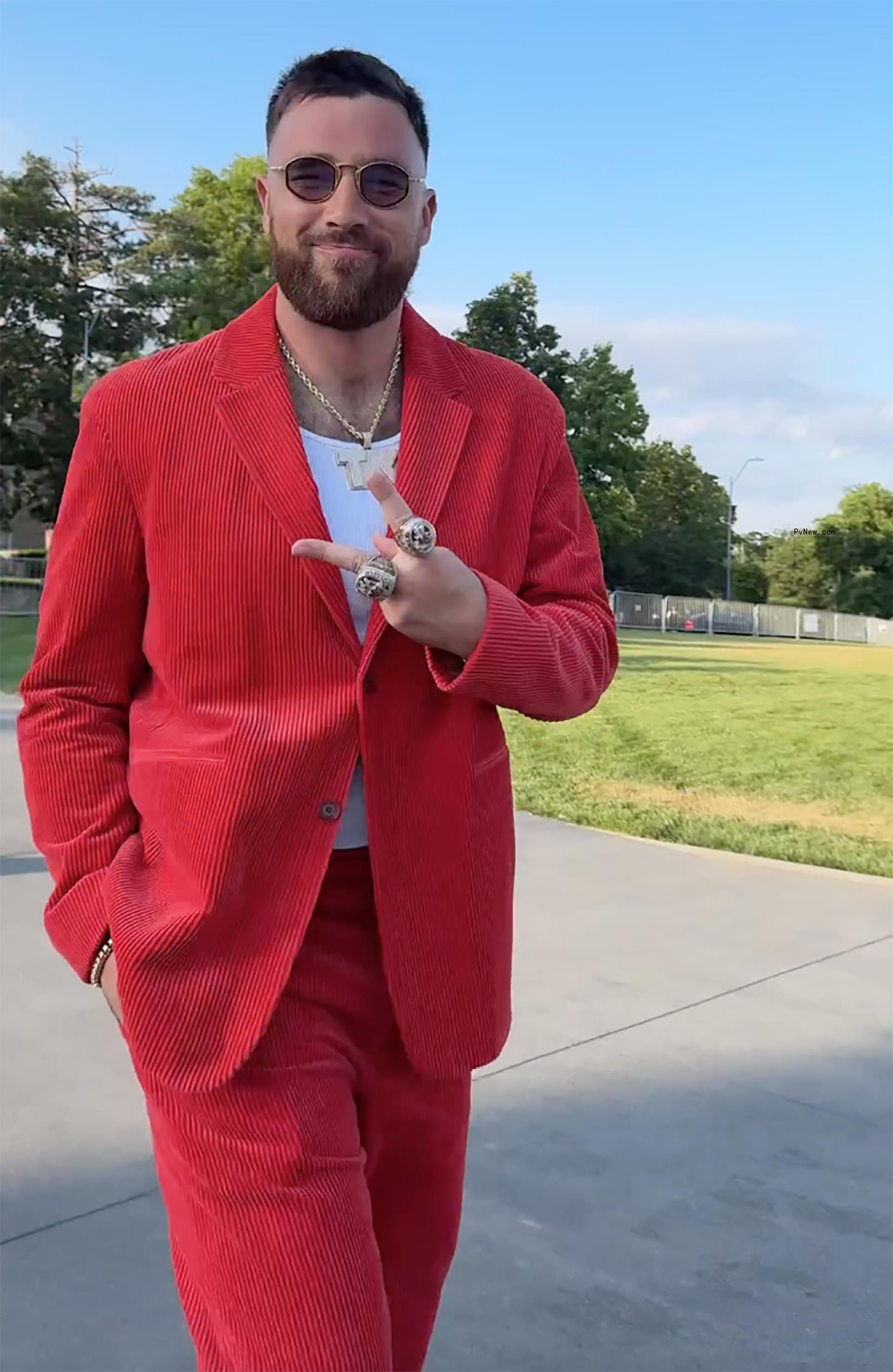 Travis Kelce throwing up a peace sign.