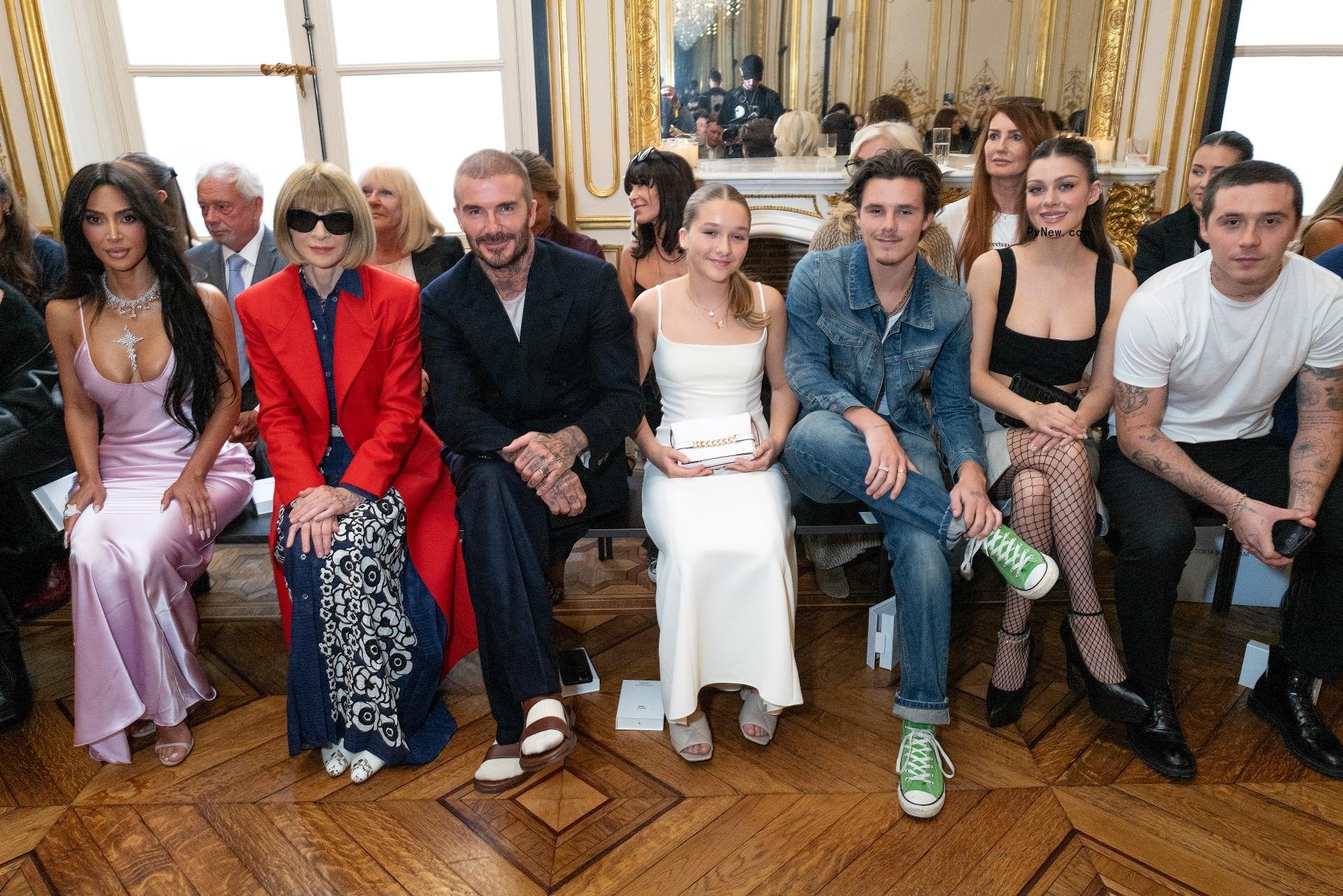 Kim Kardashian sits next to Anna Wintour alo<i></i>ngside David Beckham, Harper Beckham, Cruz Beckham, Nicola Peltz Beckham and Brooklyn Beckham.