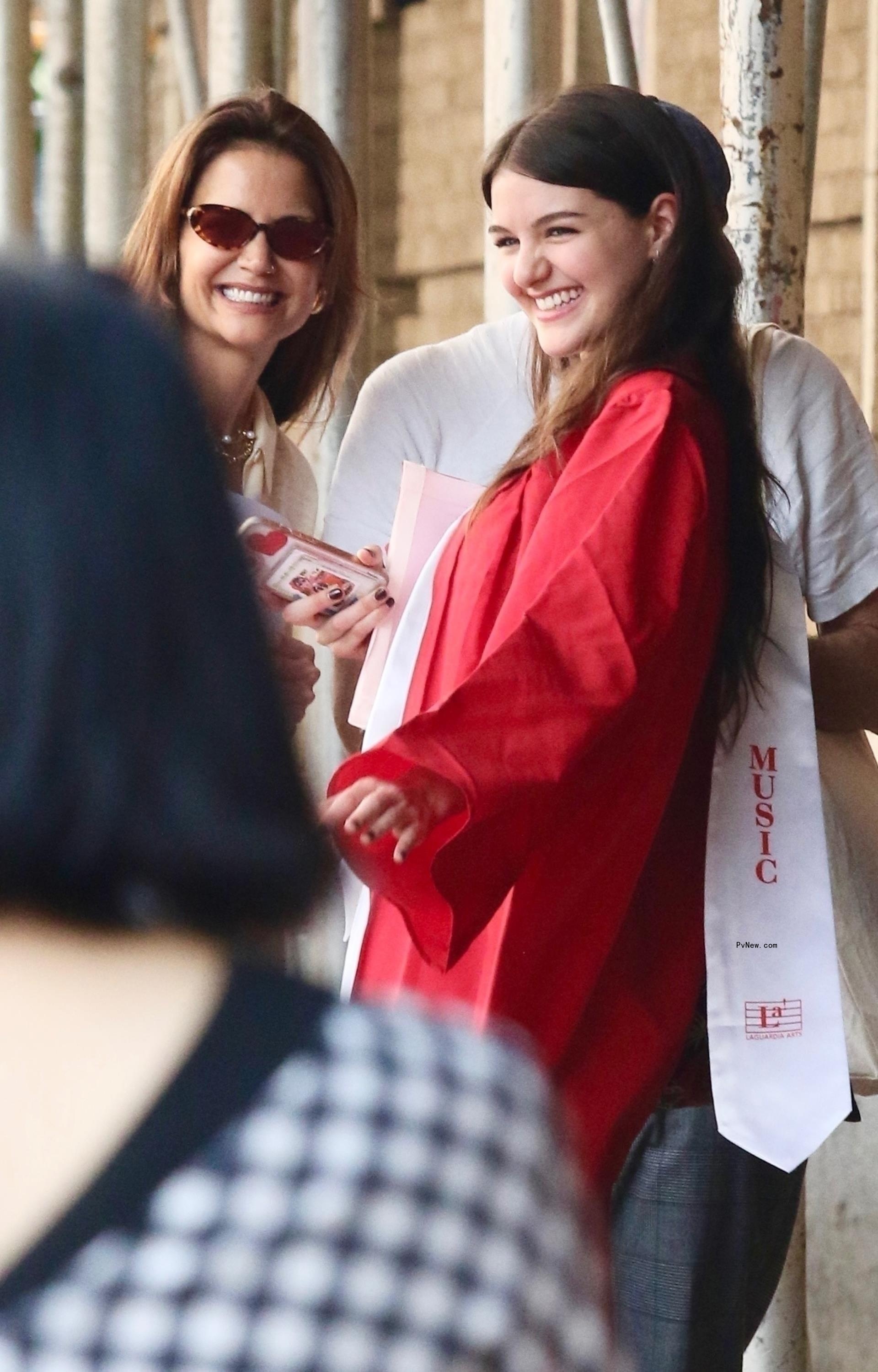 Katie Holmes smiles with her daughter Suri after she graduates high school