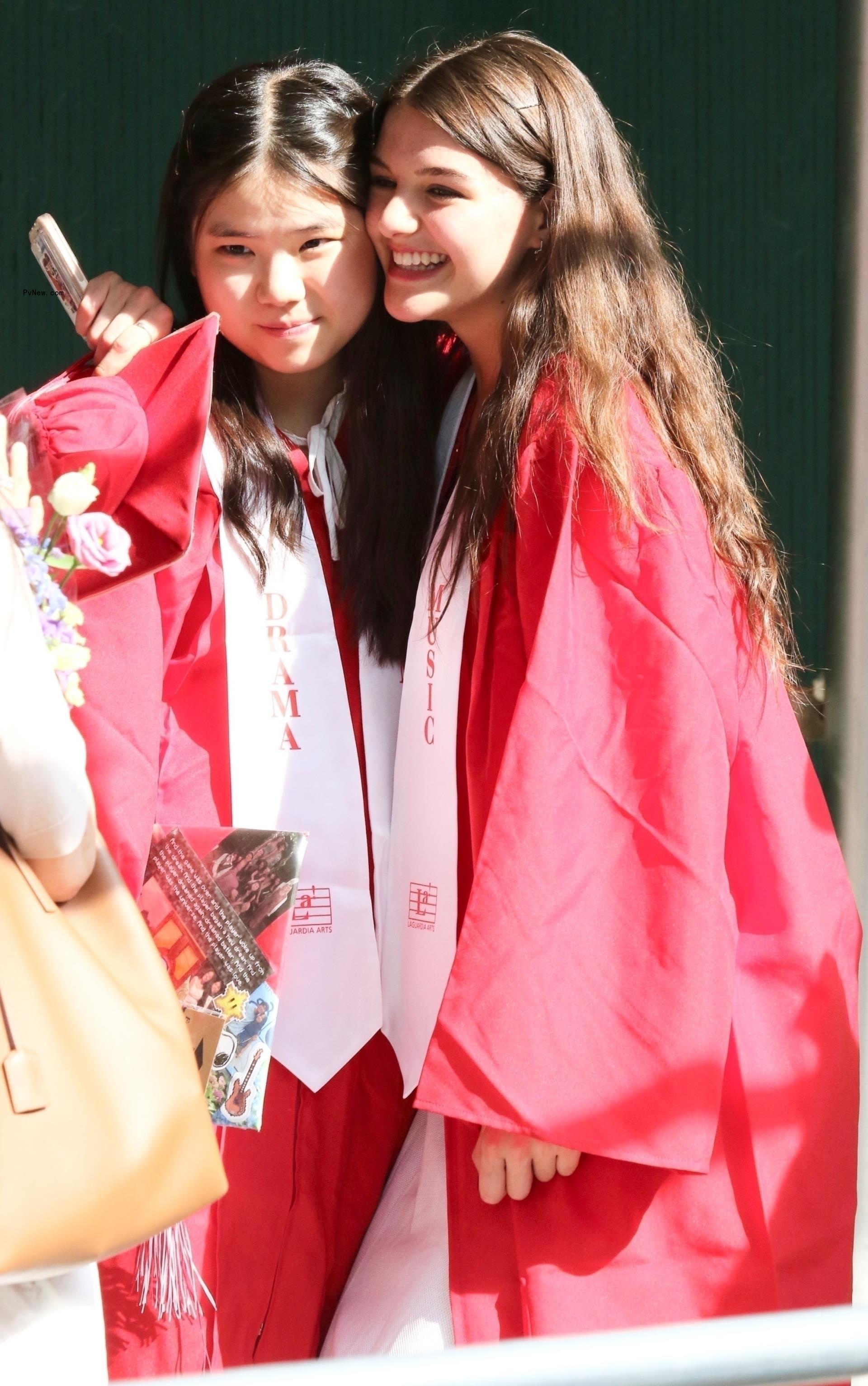 Suri Cruise smiles with a friend after she graduates high school