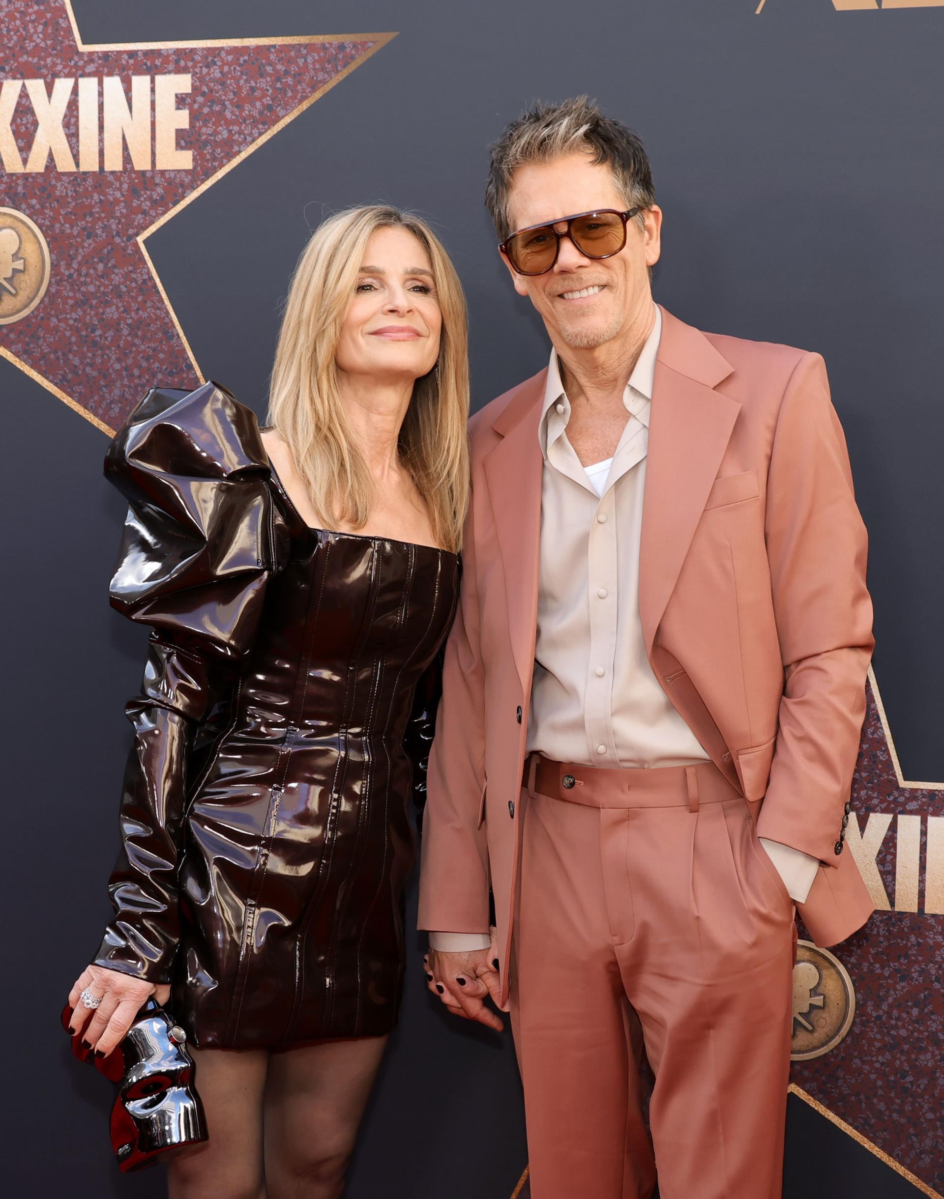 Kyra Sedgwick and Kevin Bacon posing together 
