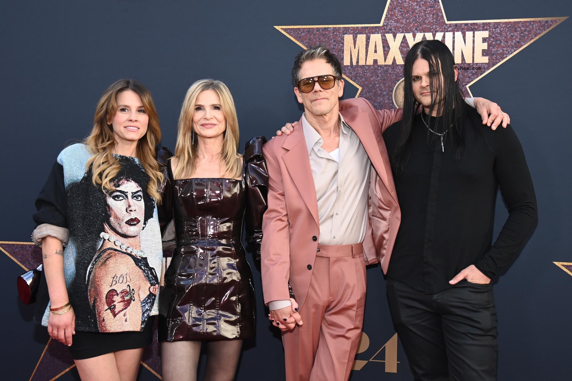 Sosie Bacon, Kyra Sedgwick, Kevin Bacon and Travis Bacon posing on a red carpet