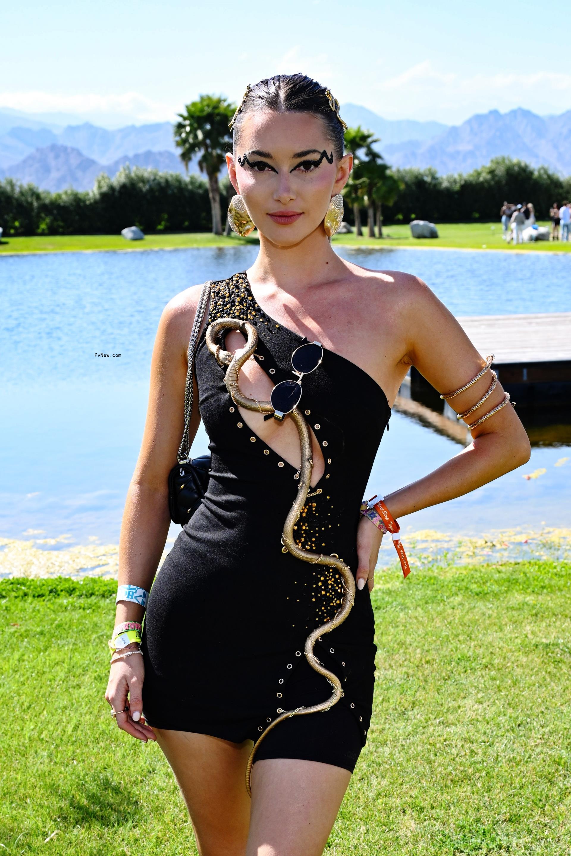 Phoebe Gates in a black-and-gold dress.