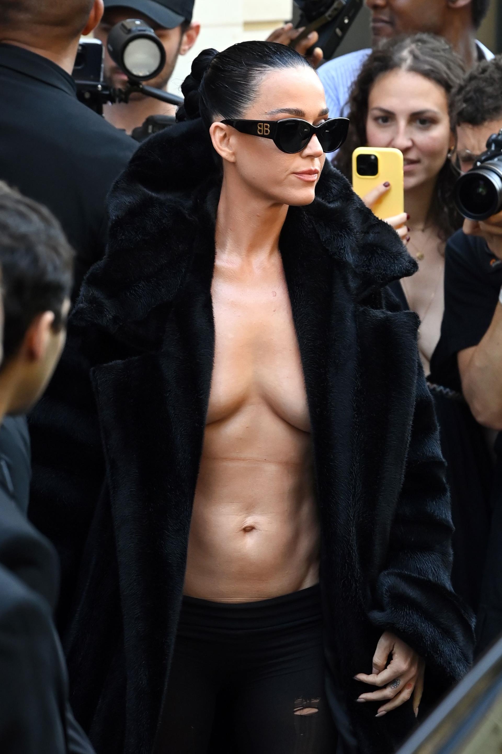 Katy Perry wearing a fur coat with no shirt at the Balenciaga Fall 2024 Couture show