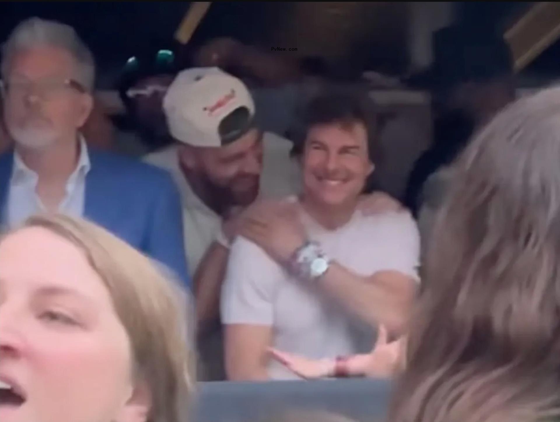 Travis Kelce and Tom Cruise at a concert.