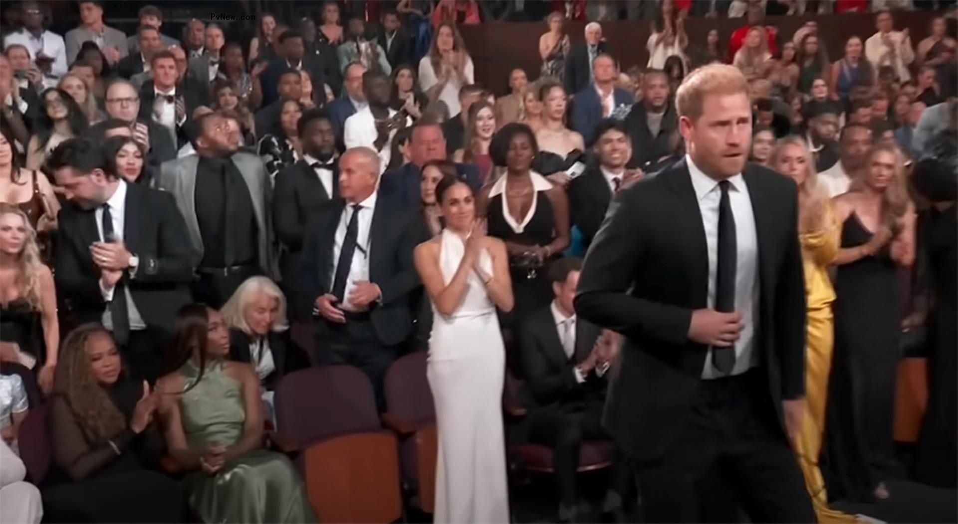 Prince Harry and Meghan Markle standing at the ESPYs