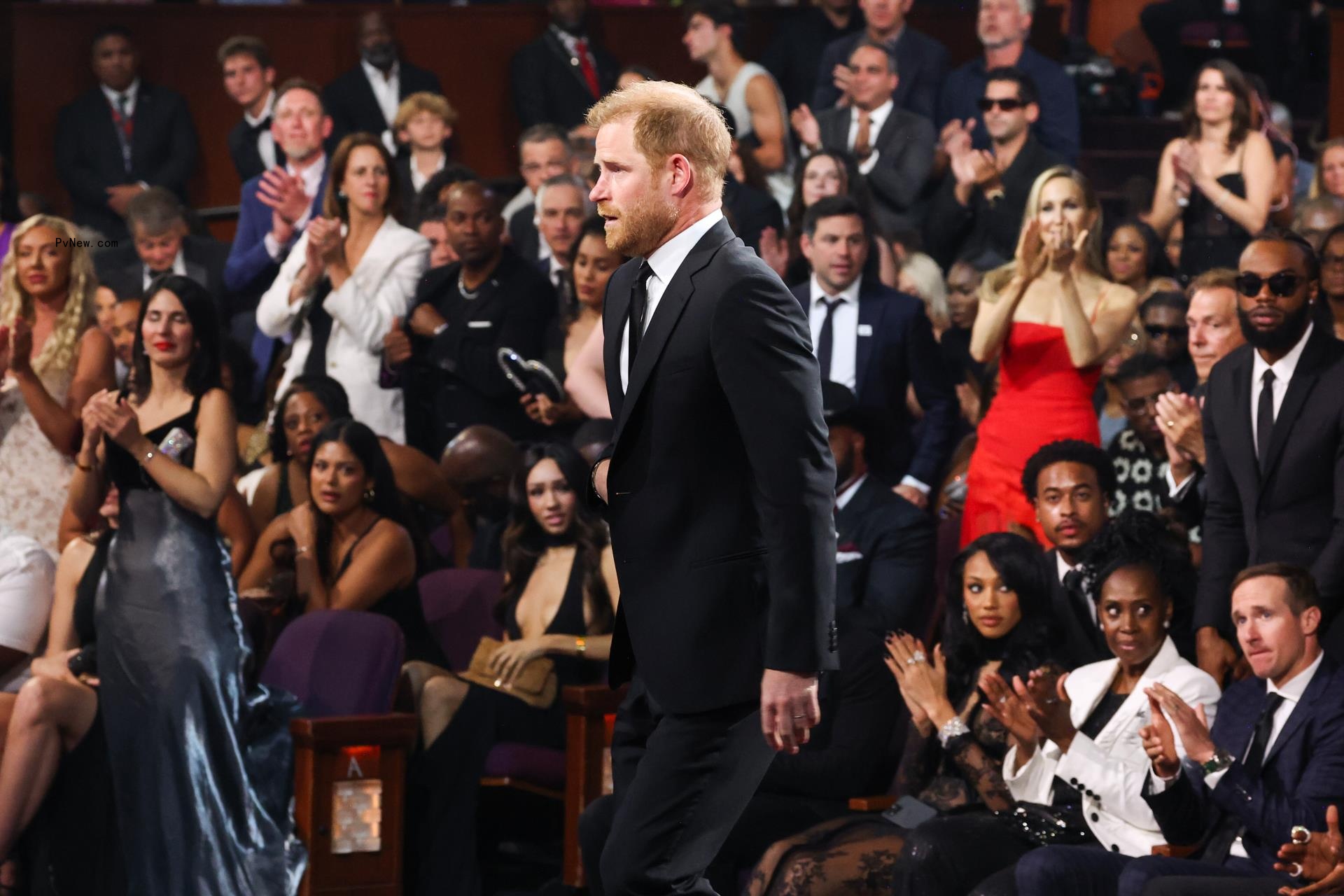 Prince Harry standing up to accept his award at the ESPYs 2024
