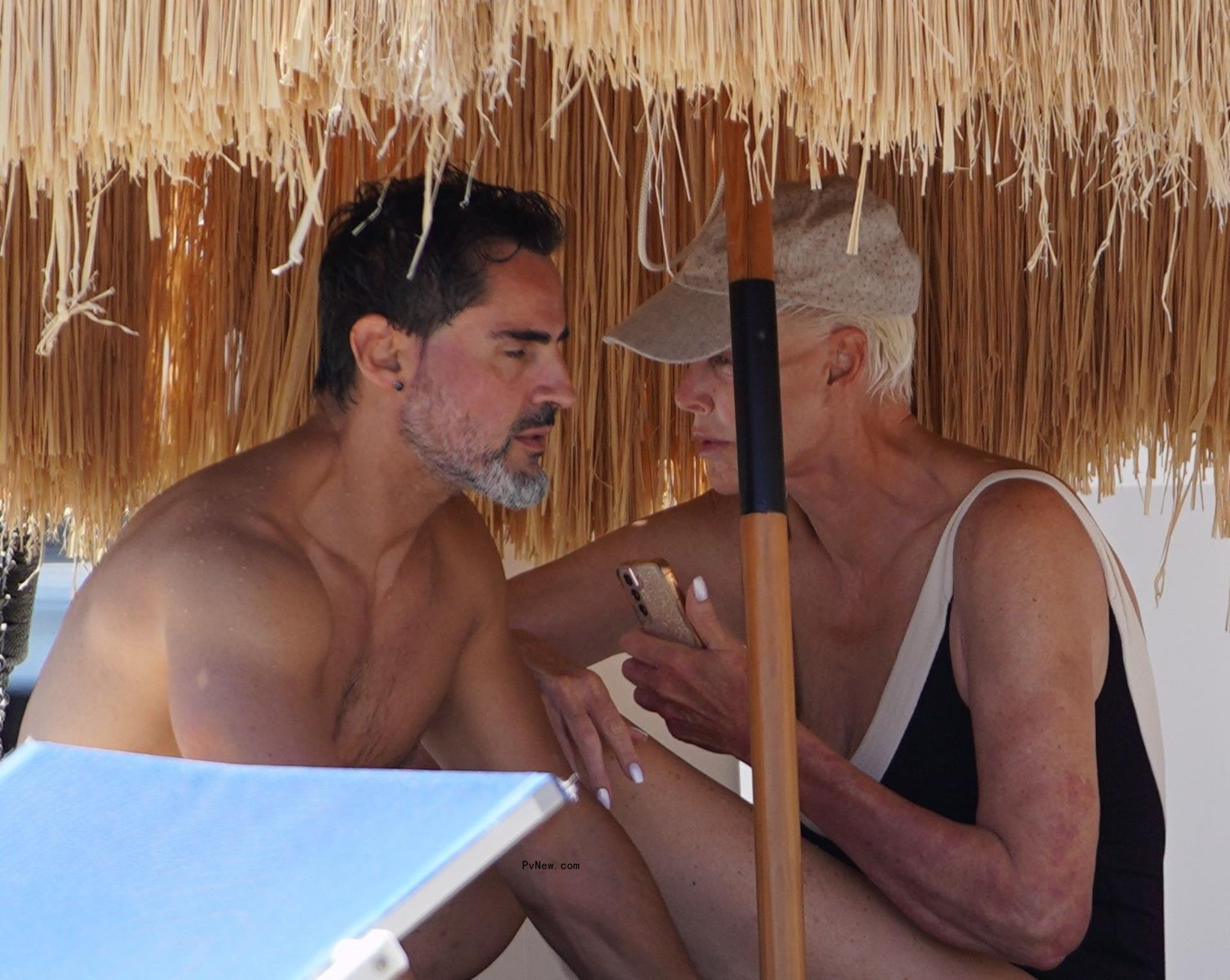 Brigitte Nielsen wears a plunging black bathing suit in Italy