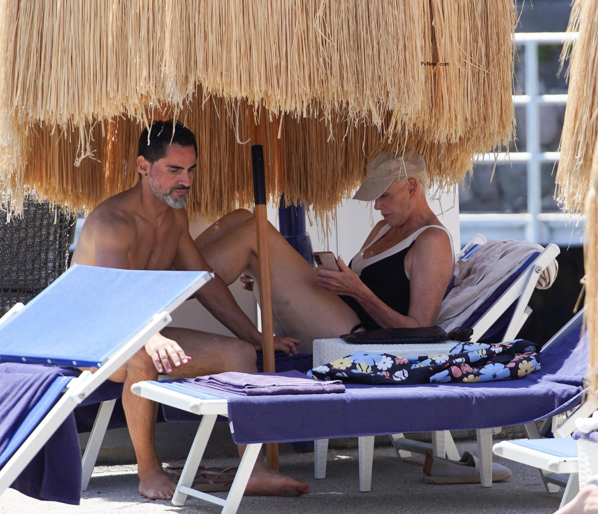 Brigitte Nielsen wears a plunging black bathing suit in Italy