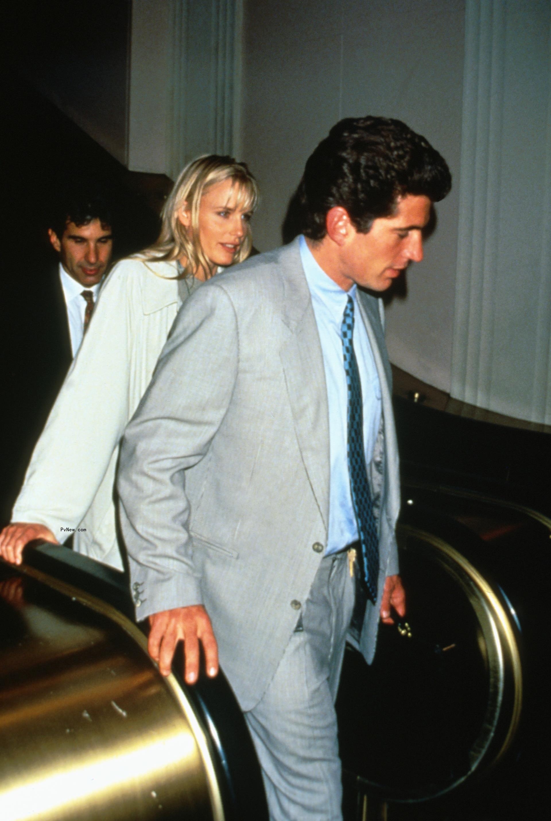 JFK Jr. and Daryl Hannah stepping off an escalator