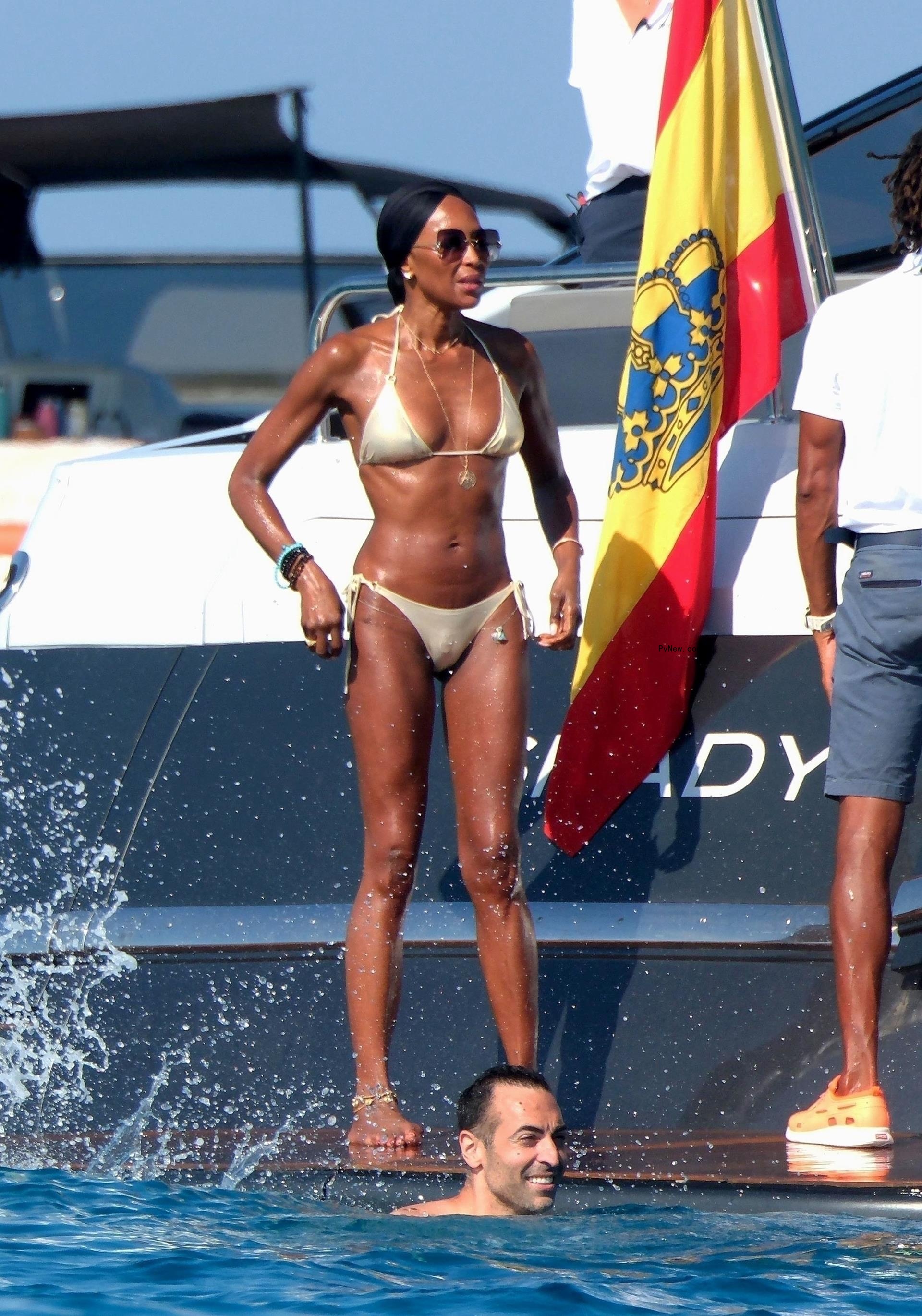 Naomi Campbell in a gold bikini.