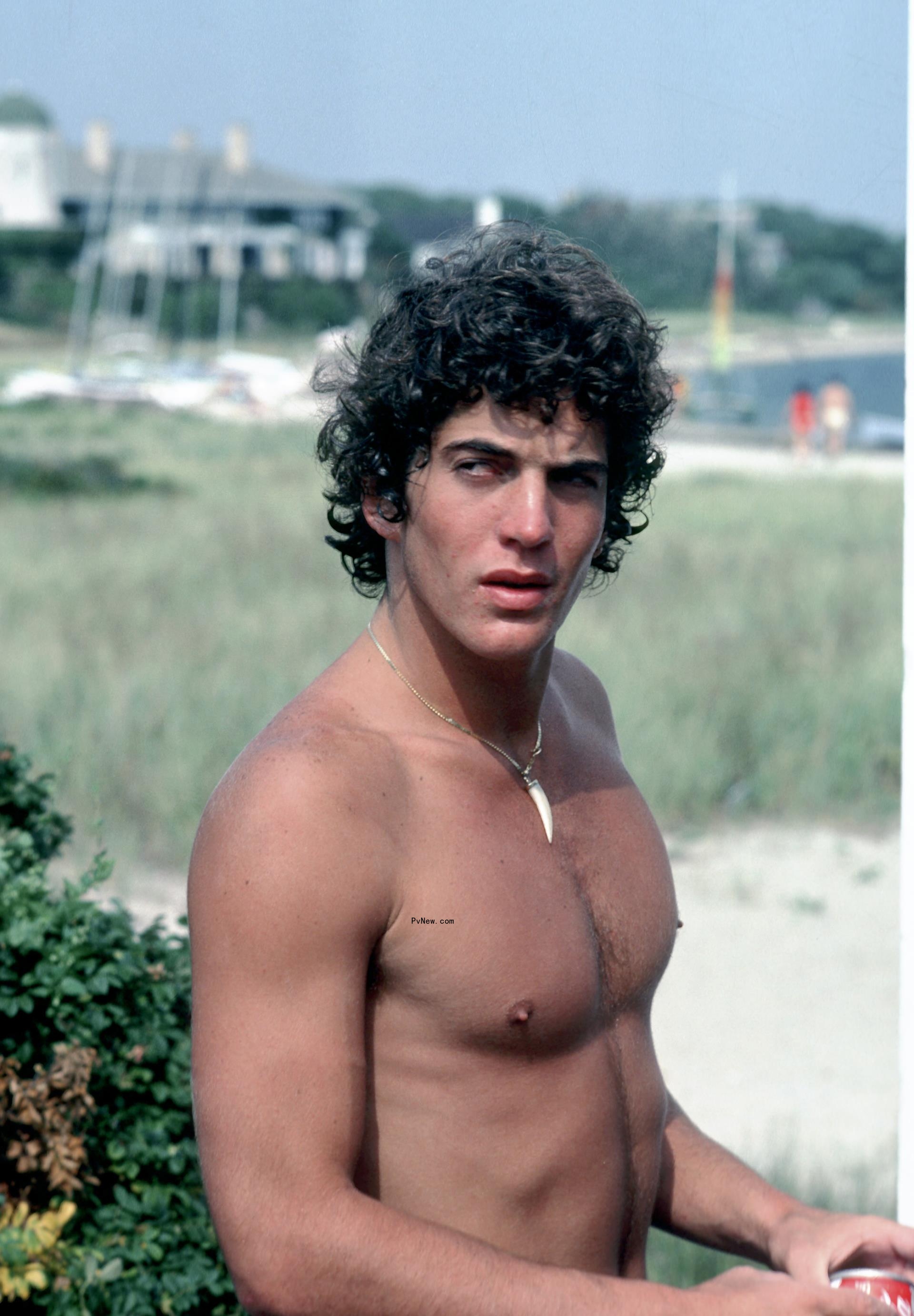 John F. Kennedy Jr. shirtless and outdoors