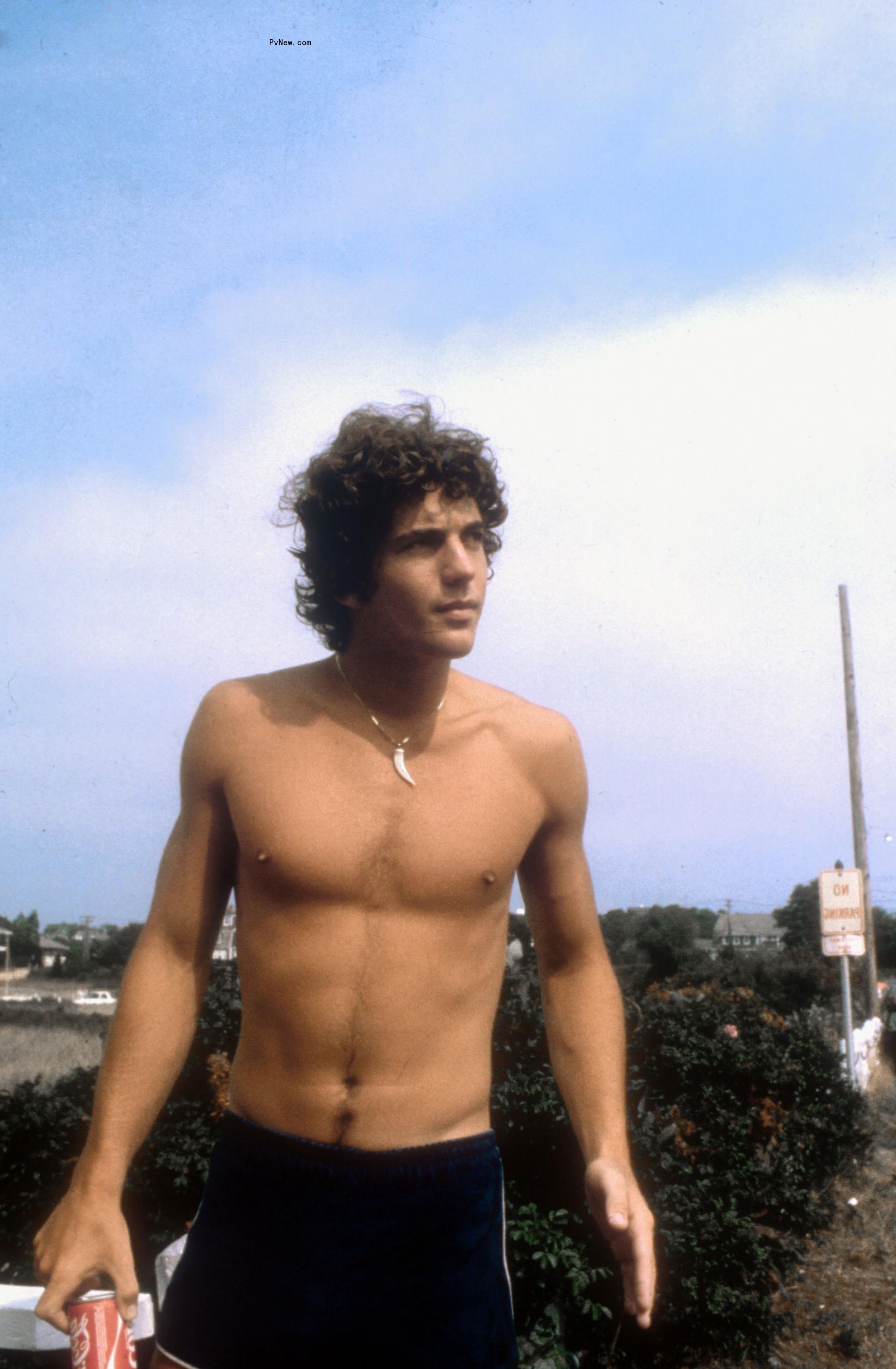 John F. Kennedy Jr. shirtless and outdoors