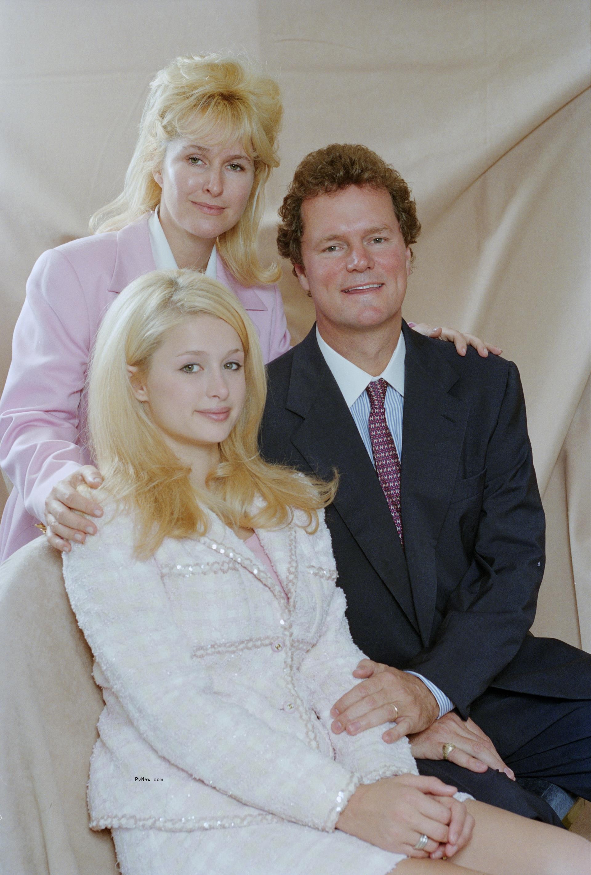 Paris Hilton posing with her parents, Kathy Hilton and Rick Hilton.