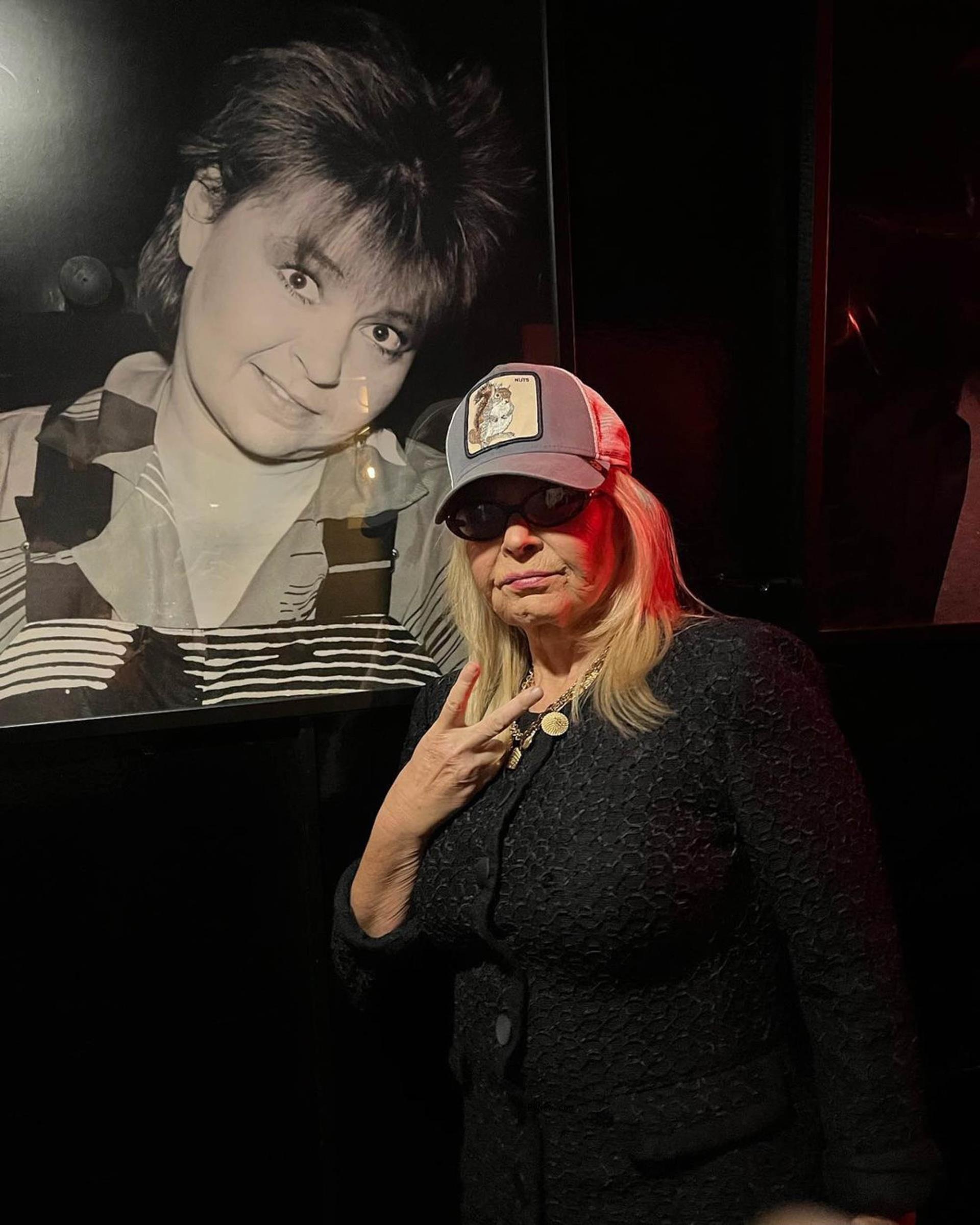 Roseanne Barr giving a peace sign.