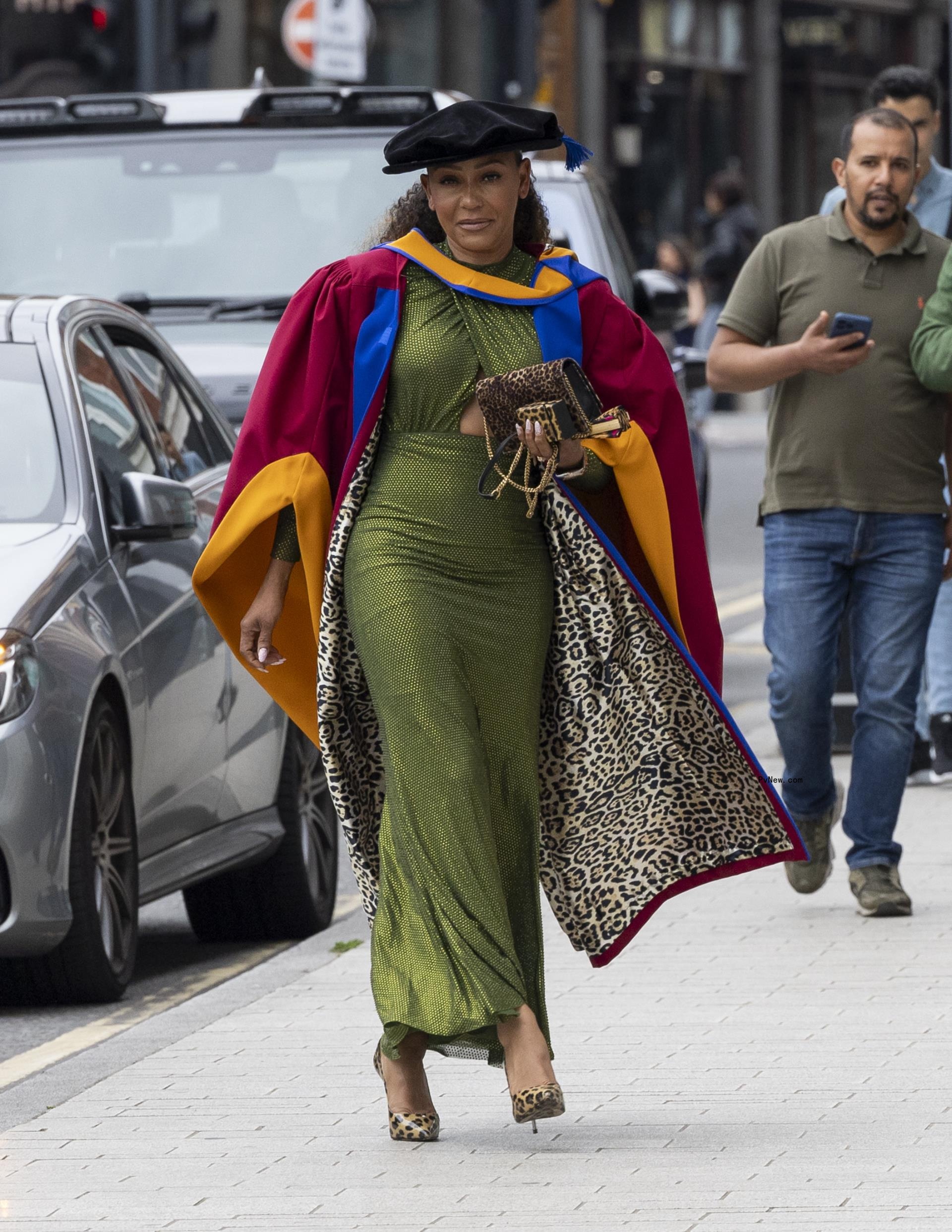 Mel B wearing a leopard print graduation gown and green dress