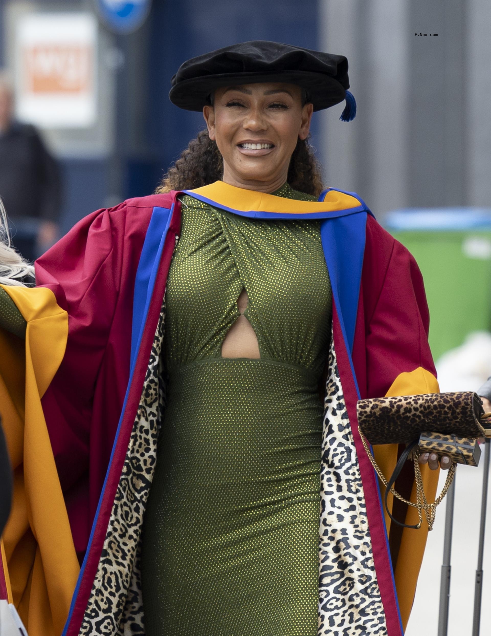 Mel B wearing a leopard print graduation gown and green dress