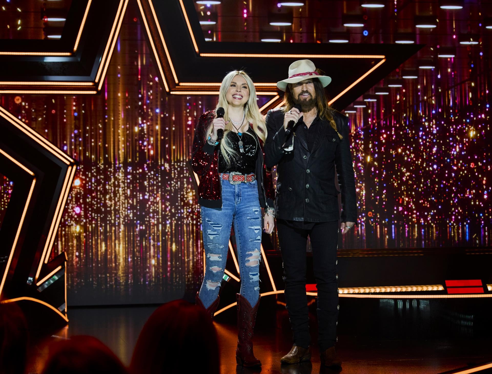 Firerose Cyrus and Billy Ray Cyrus on stage together.