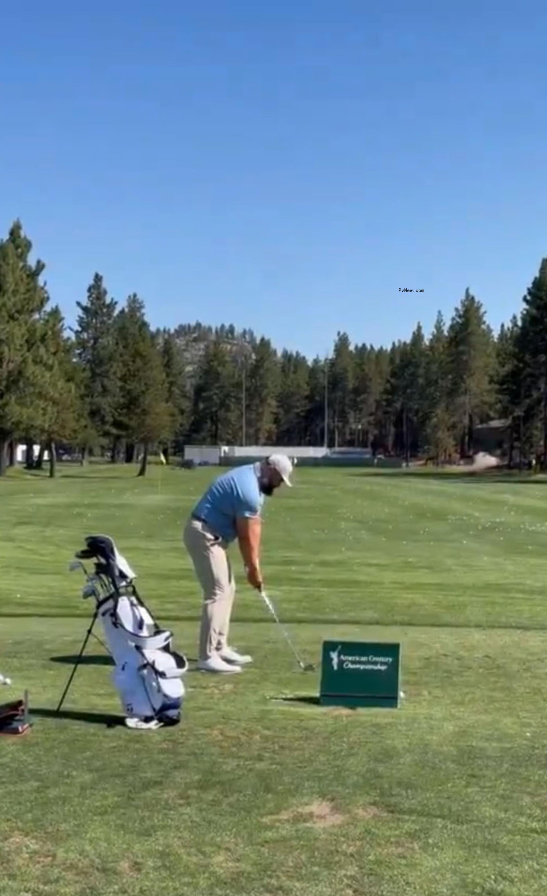 jason kelce getting ready to hit a golf ball