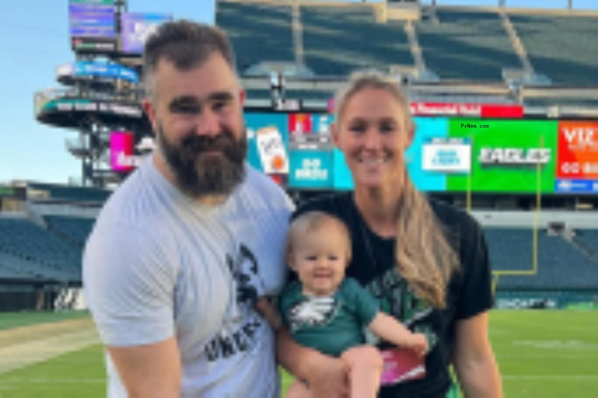 jason kelce kissing his wife, kylie, on the cheek in a field of lavender