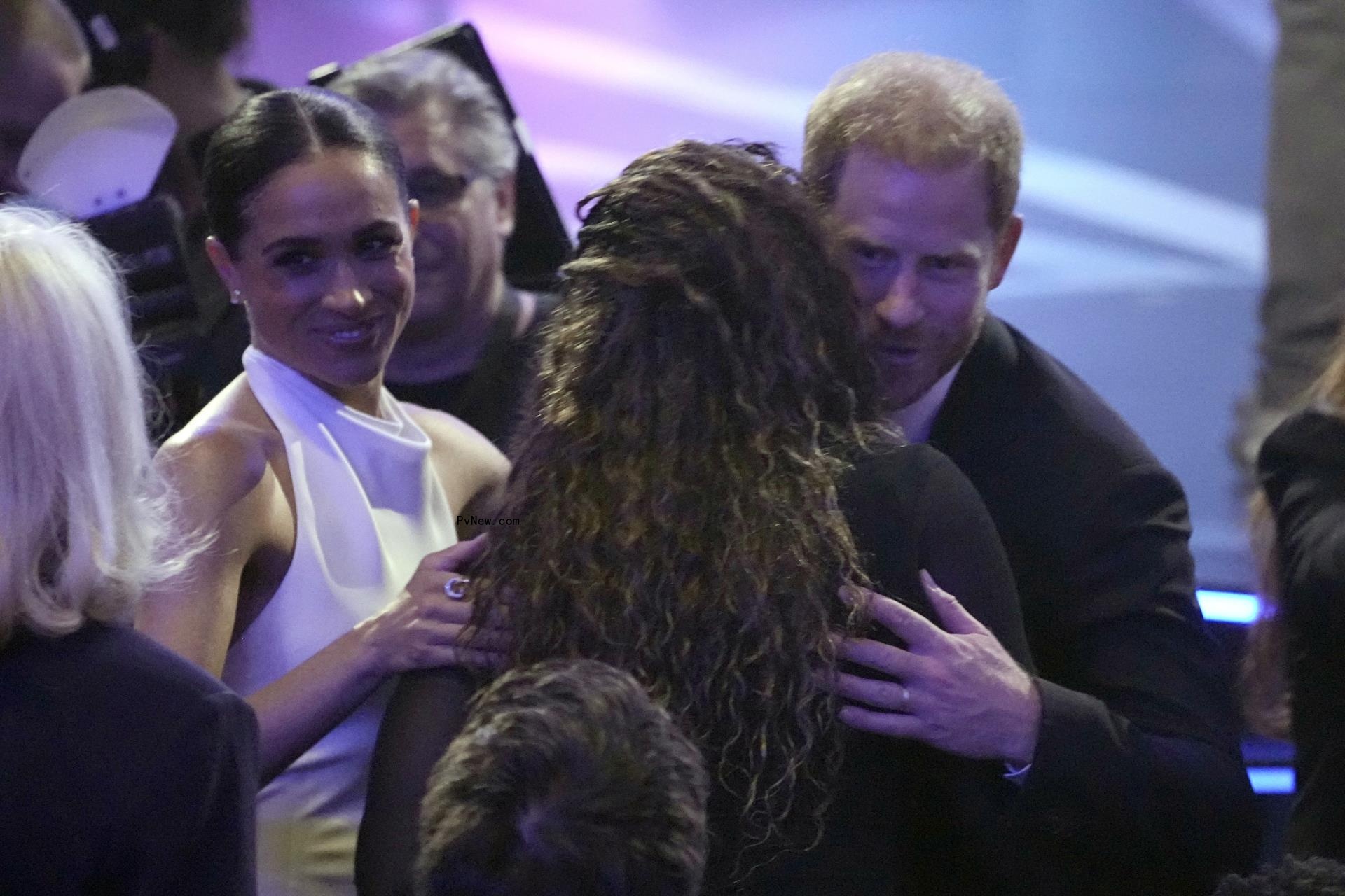 Prince Harry and Meghan Markle hugging Serena Williams