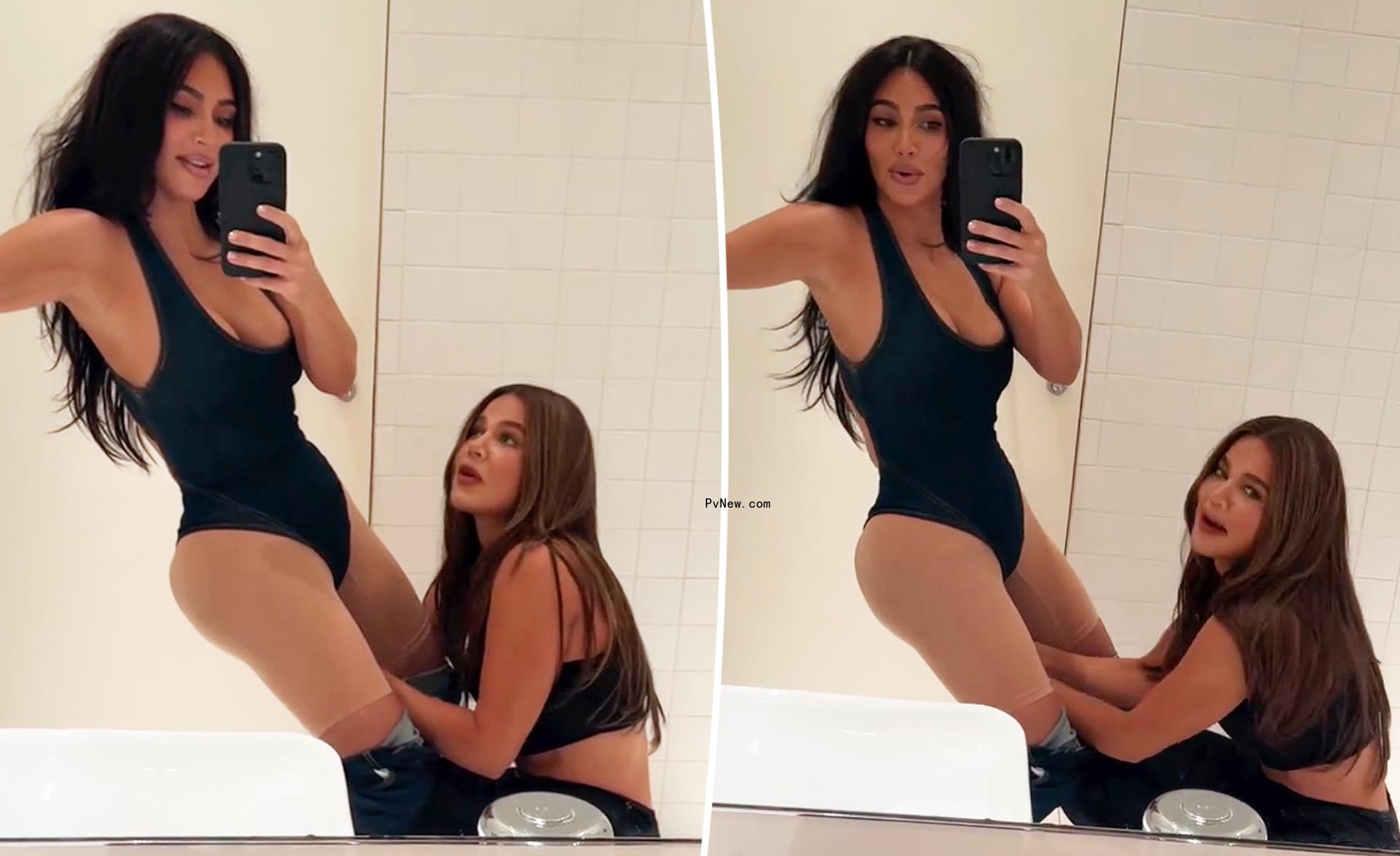 Khloé Kardashian trying to snap on Kim Kardashian bodysuit