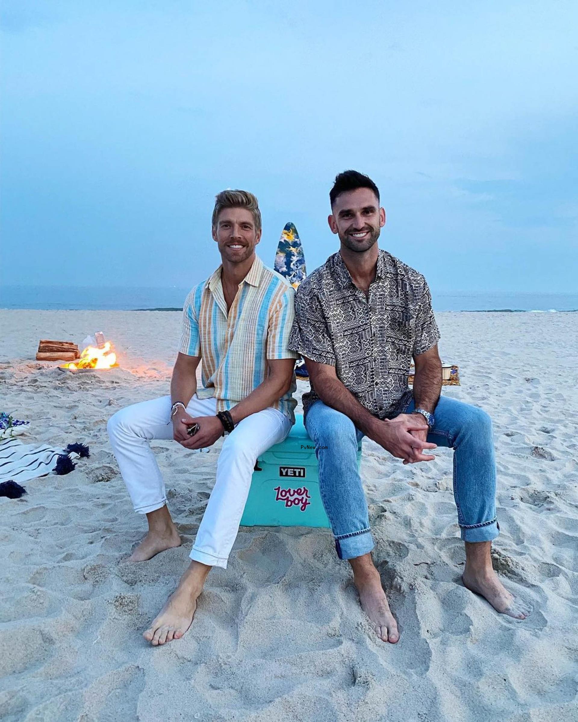 Carl Radke and Kyle Cooke sitting on a beach together
